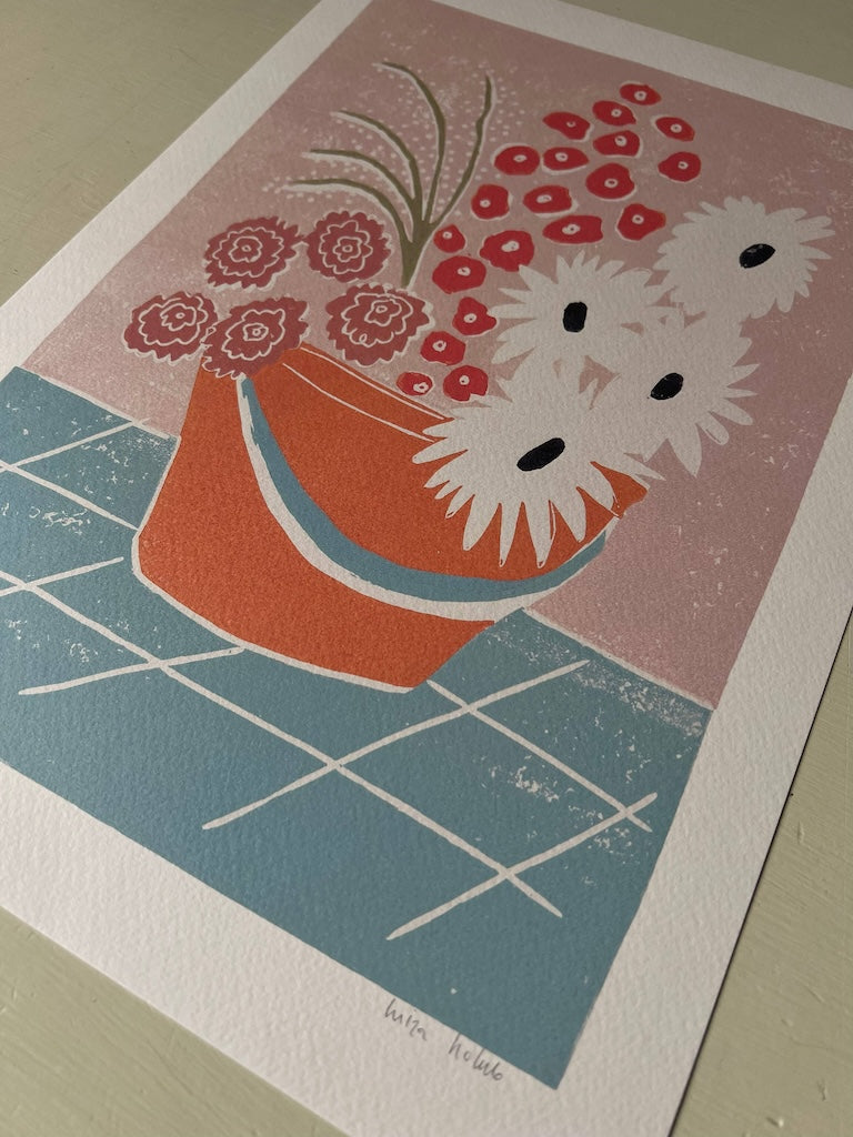 This print features an orange bucket full of colourful flowers.