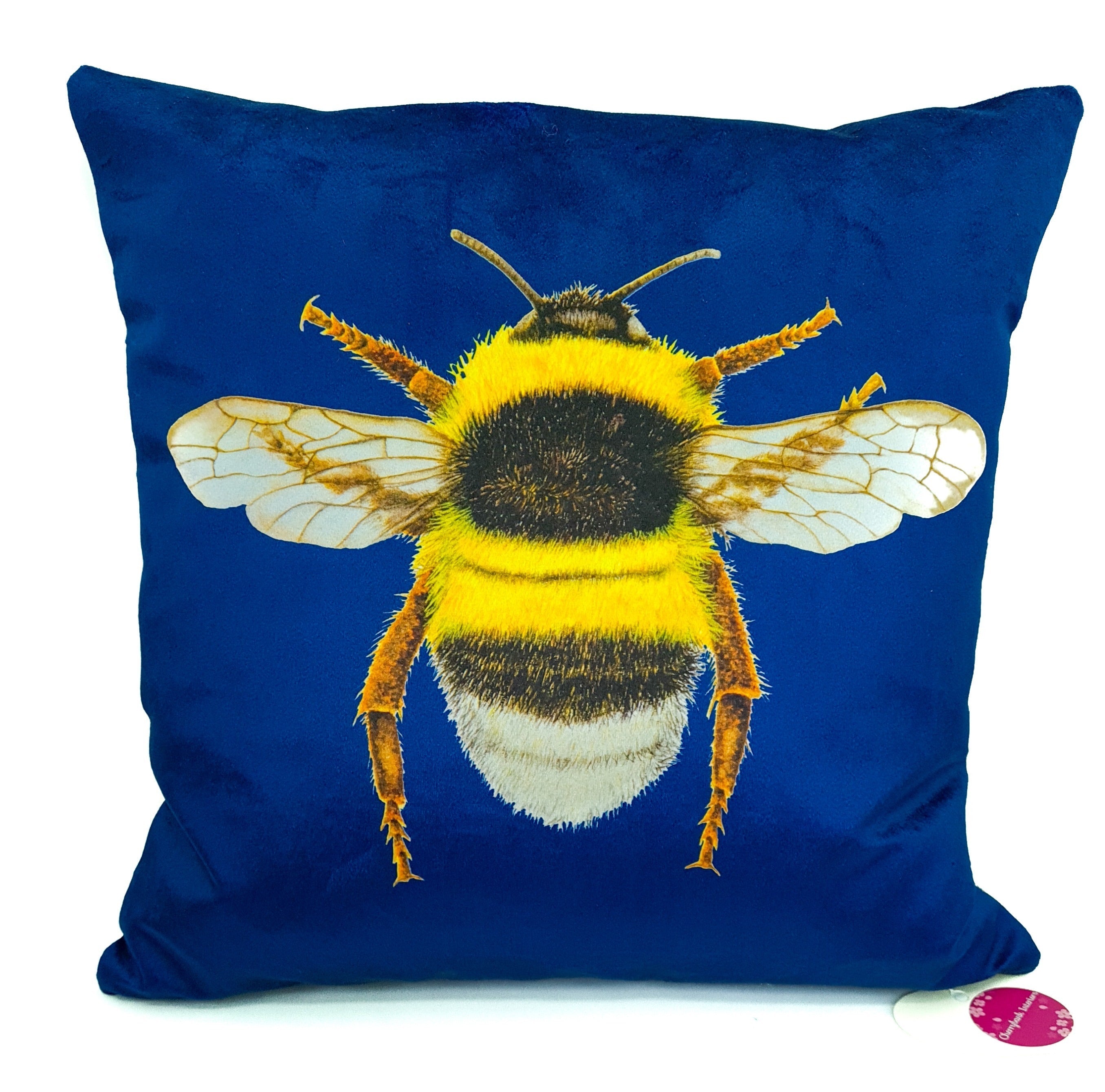 Blue velvet cushion with a bumblebee on the front.