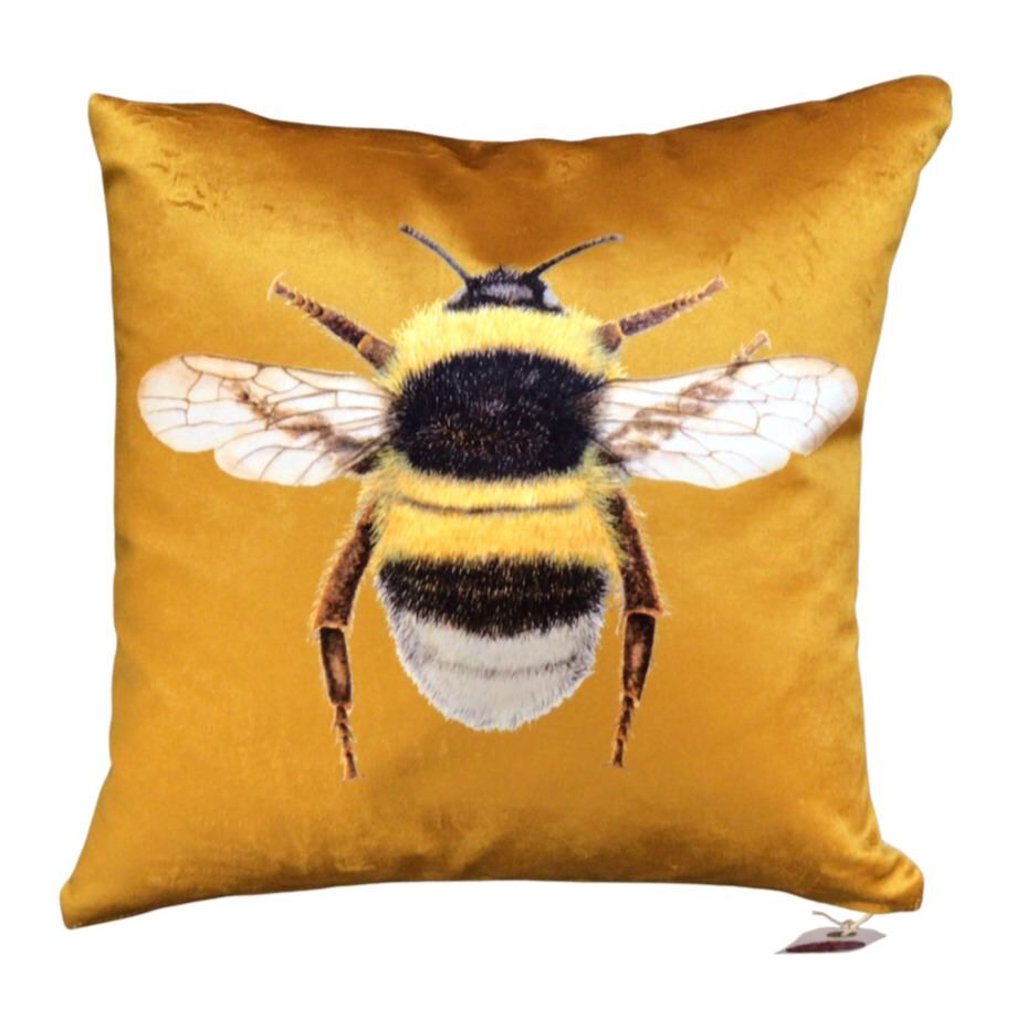 Gold velvet cushion with a bumblebee on the front.