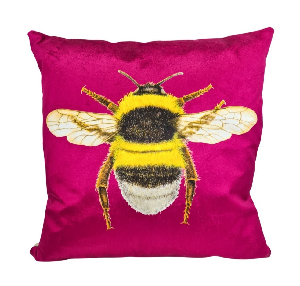 Plum velvet cushion with a bumblebee on the front.