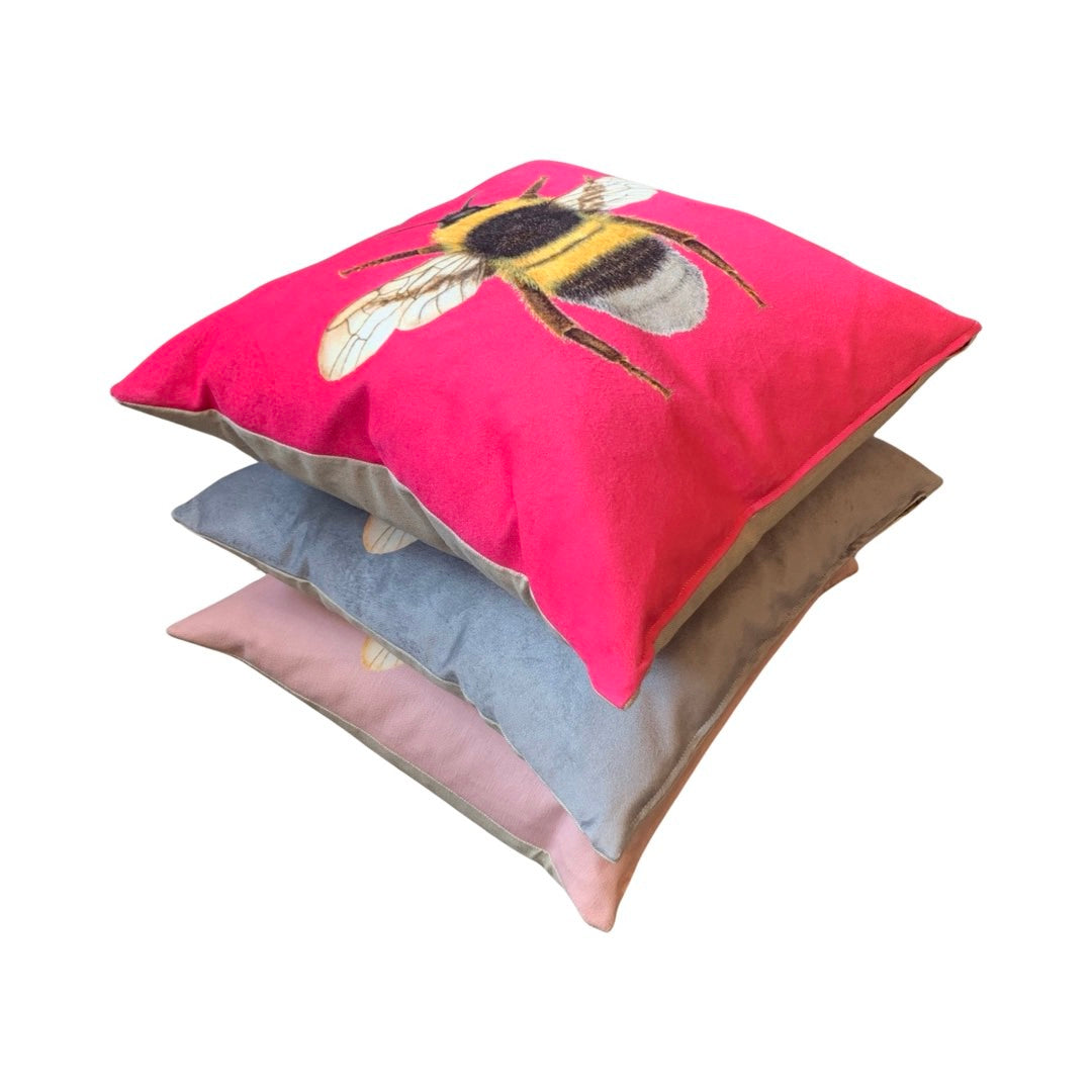 Stack of cushions with the top one displaying a bumblebee design.