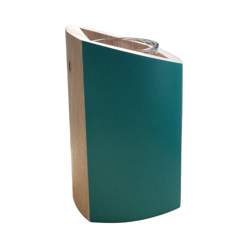The side of a wooden vase with glass insert and teal sides.