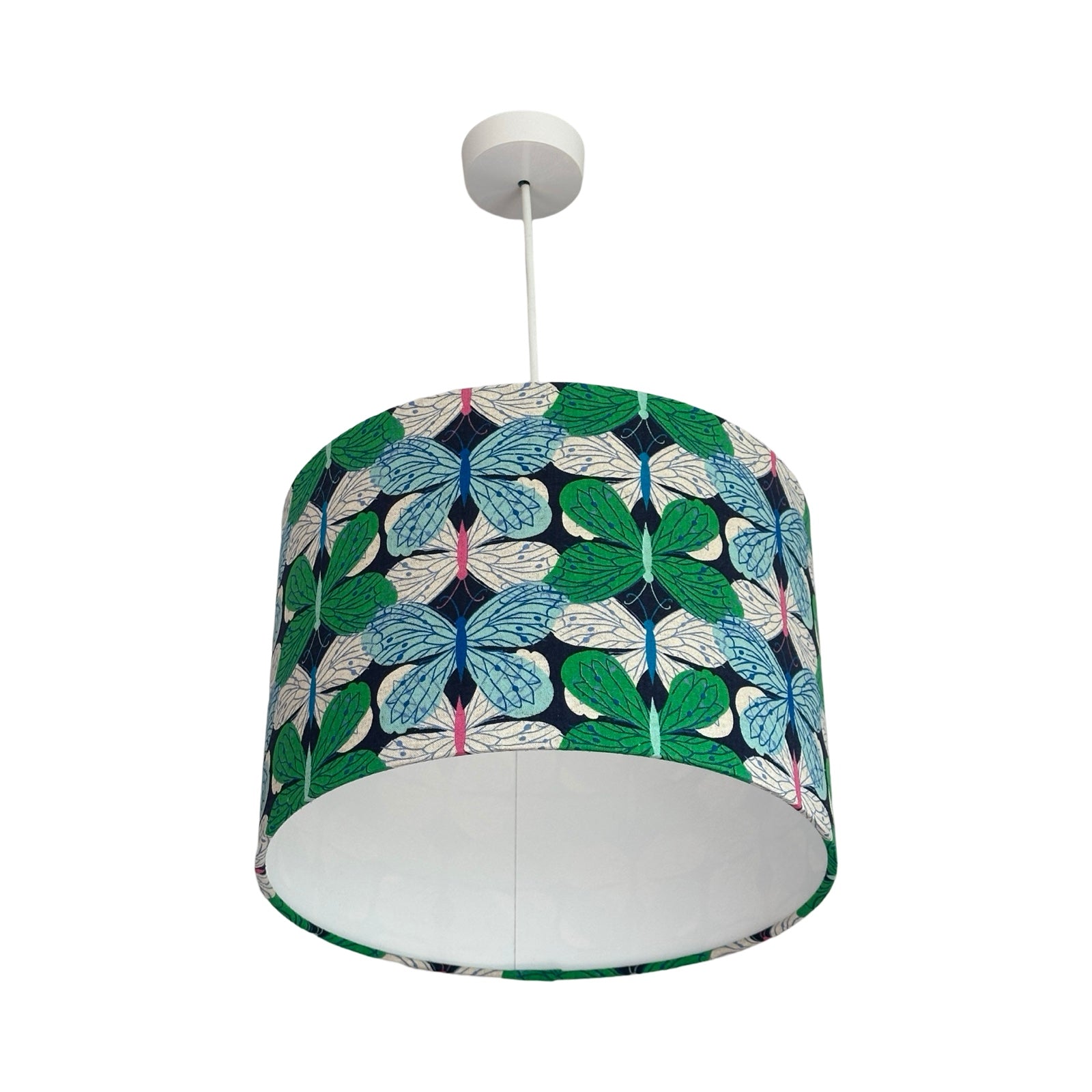 A drum lampshade covered in navy cotton/linen blend fabric with gorgeous green, pale blue and white butterflies.