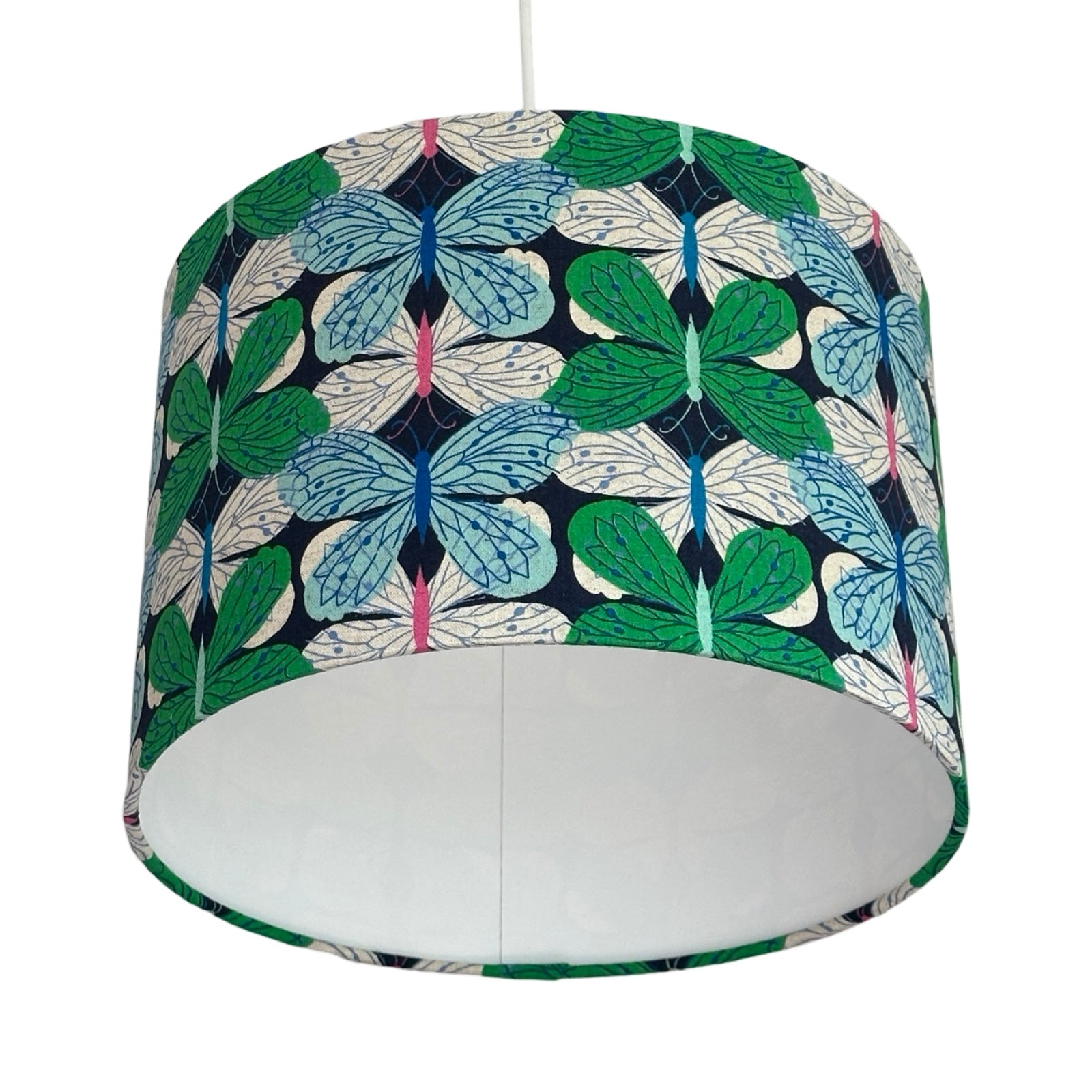A drum lampshade covered in navy cotton/linen blend fabric with gorgeous green, pale blue and white butterflies.