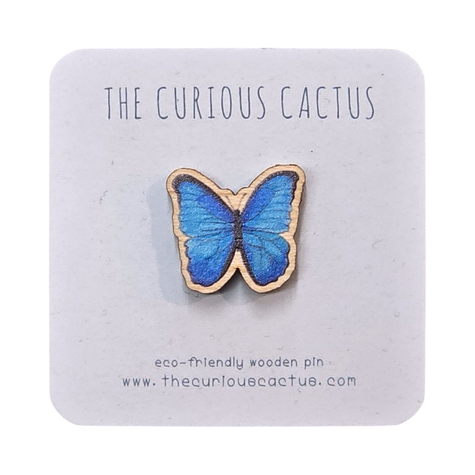 A blue butterfly-shaped mini wooden pin badge on backing card.