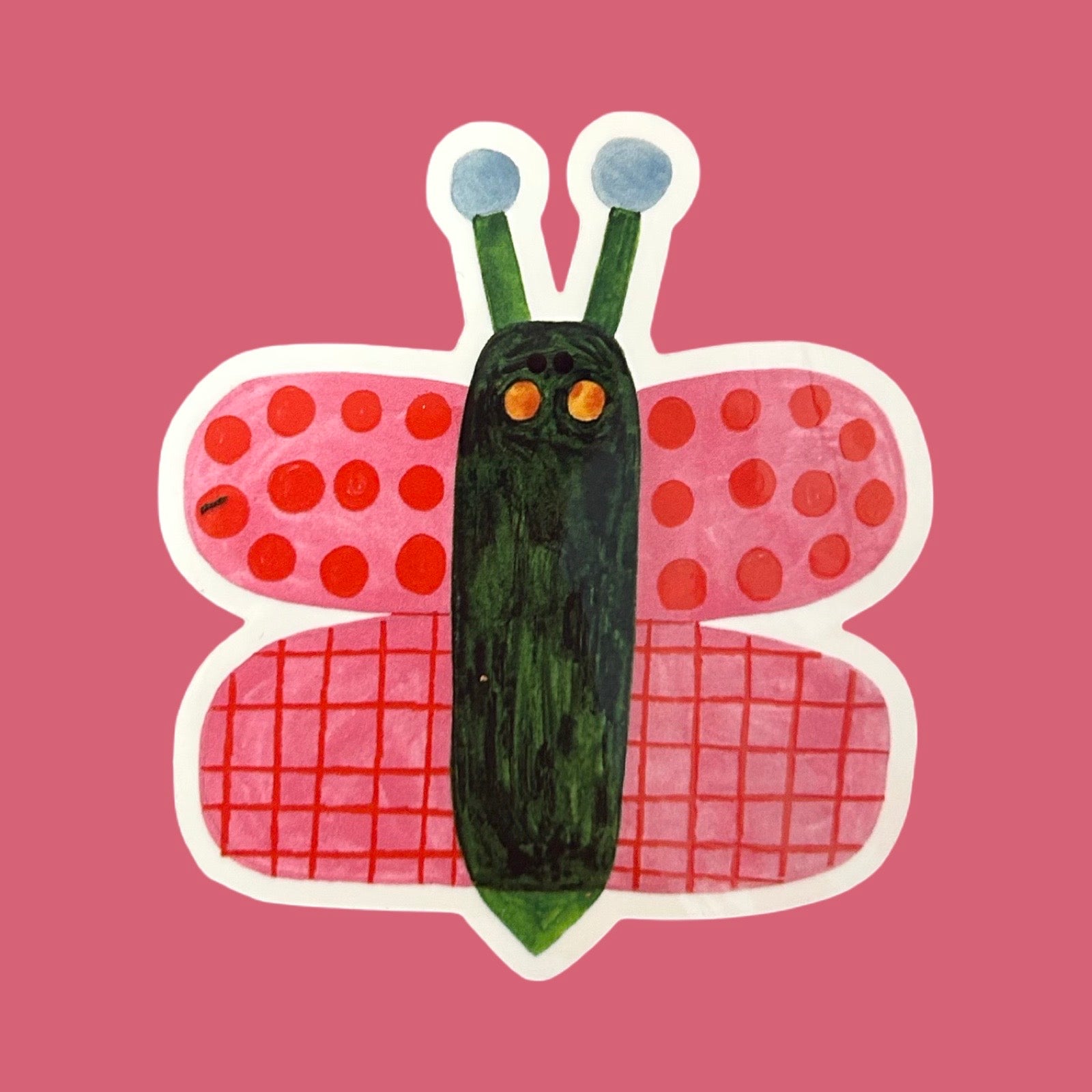 A stylised butterfly sticker or illustration on a solid pink background. The butterfly has pink wings with red polka dots and red grid patterns, a dark green body, and light blue antennae with white tips.