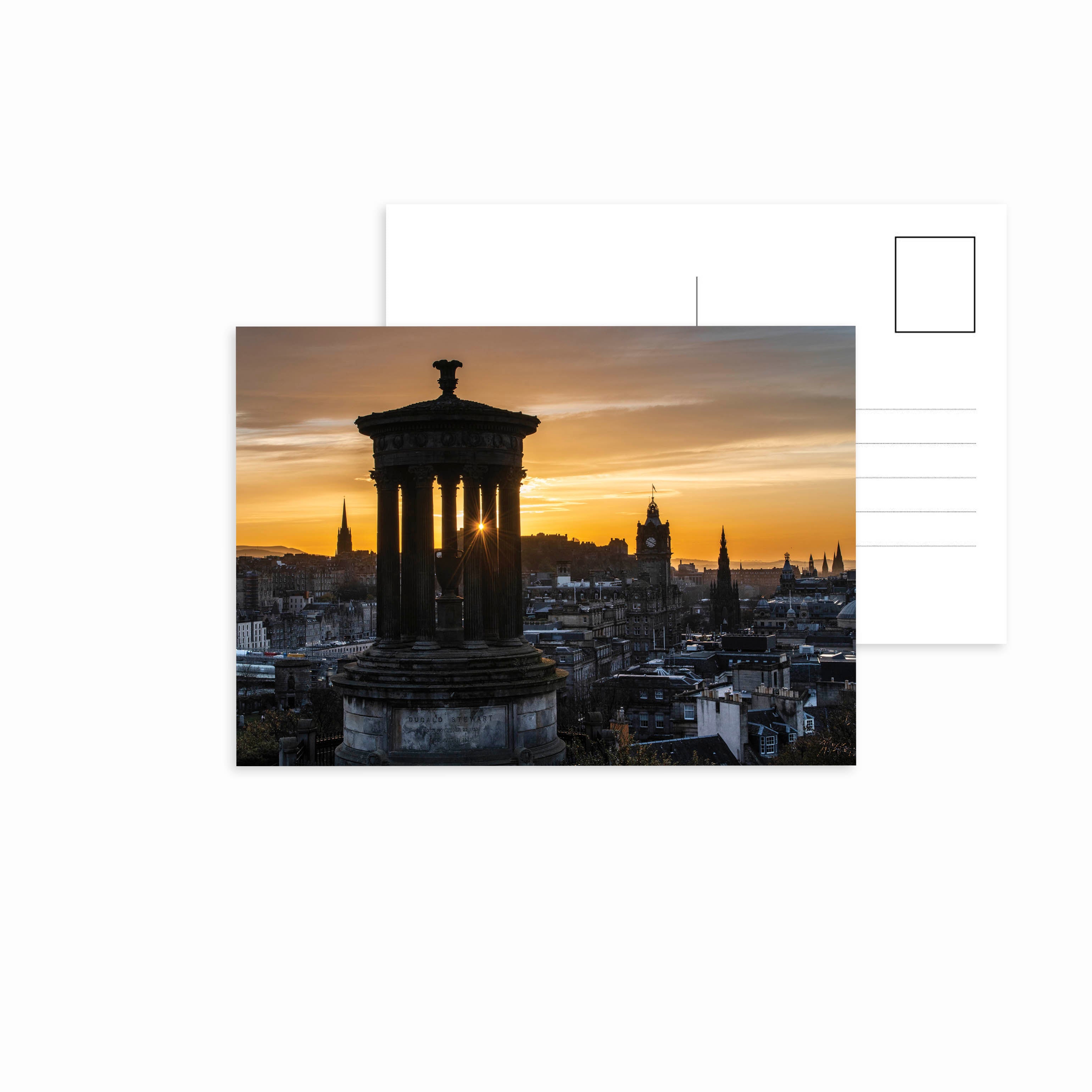 A view of Edinburgh from Calton Hill at sunset on a postcard.