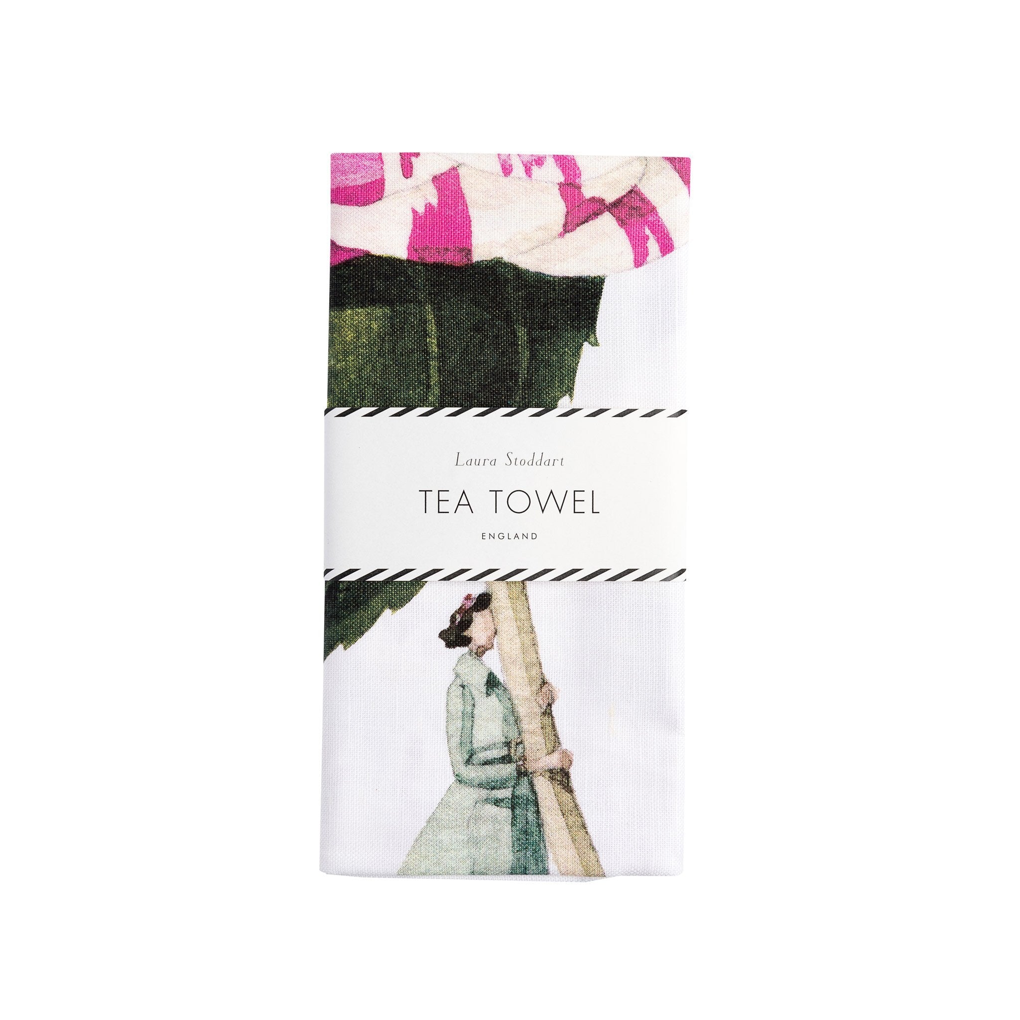 Wrapped tea towel featuring an illustration of a lady dressed in a pale blue jacket and black boots holding a giant camellia flower.
