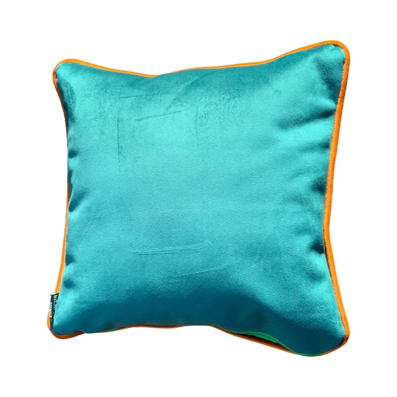 Turquoise velvet back of camouflage cats cushion with orange piping.