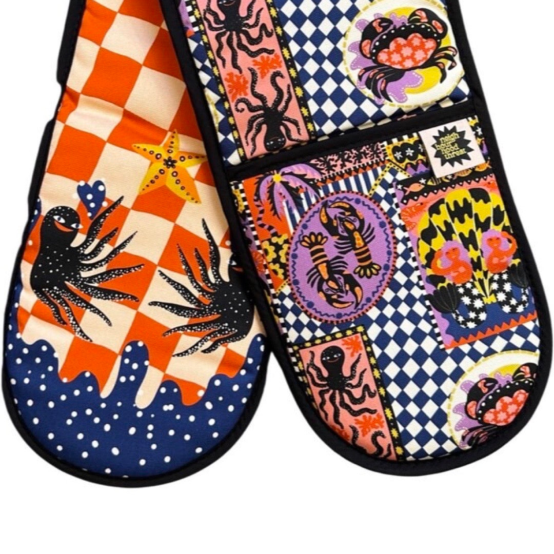 Oven gloves with a catch of the day print on one side and happy octopus on the reverse.