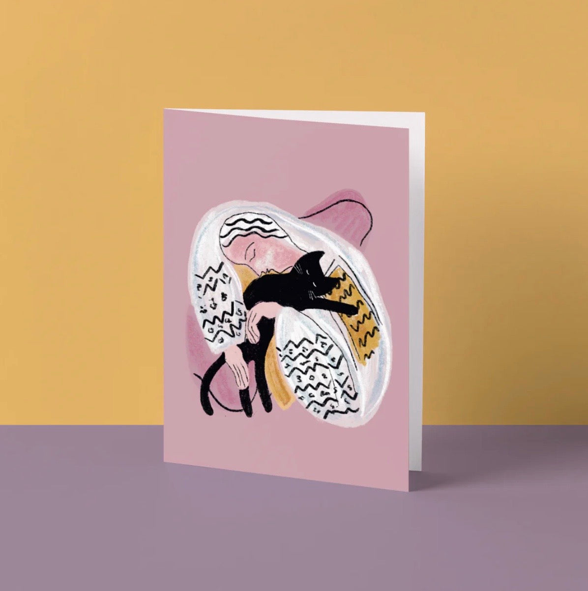 Greeting card with a stylized illustration of a woman and a black cat on a pink background.