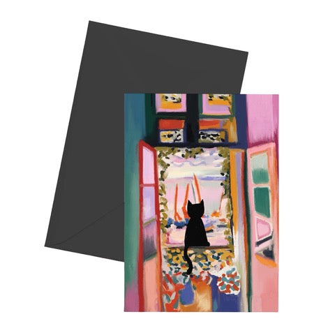 Cat card featuring a black cat sitting in the window of a colourful apartment.