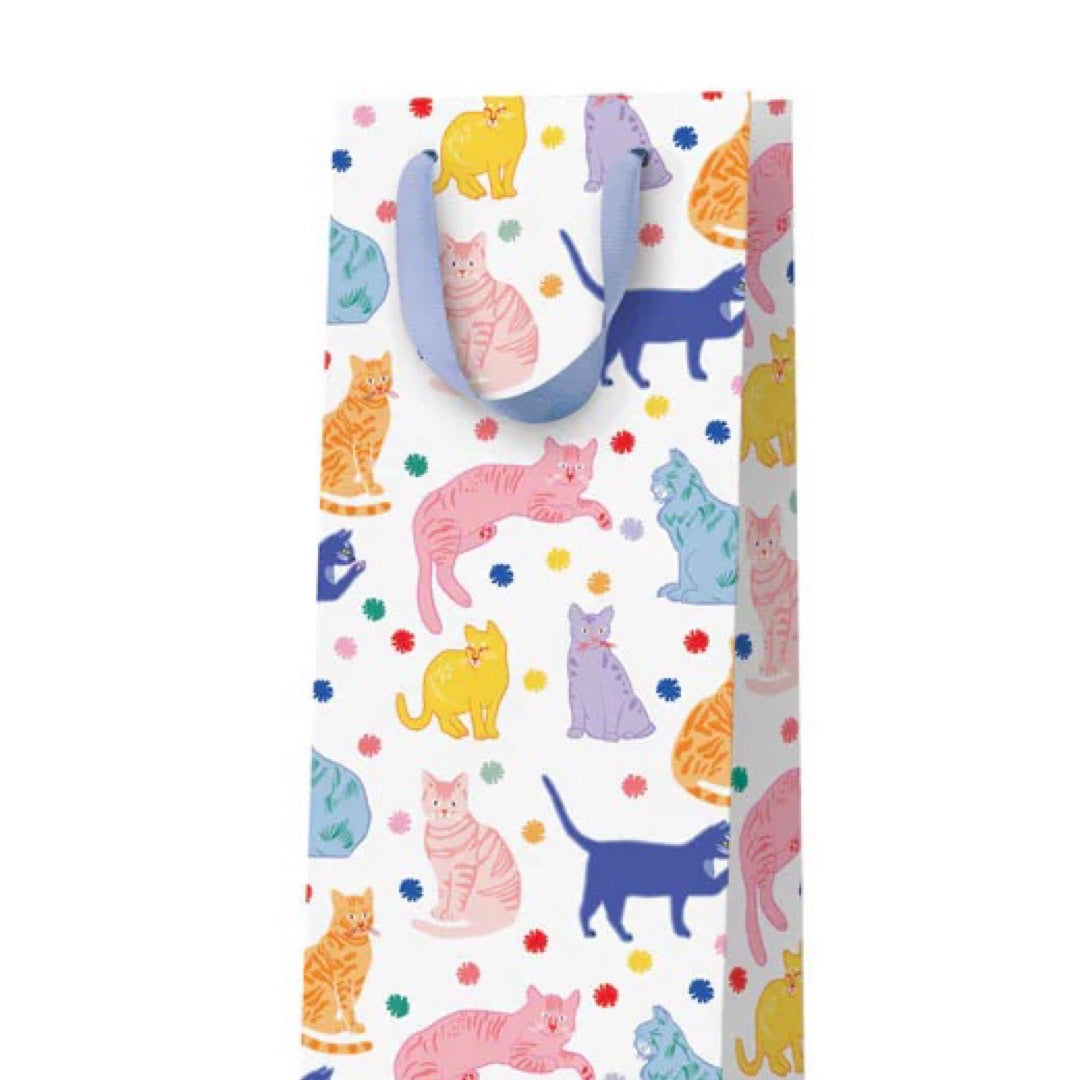 A white bottle bag with multicoloured cats and a lilac ribbon handle.
