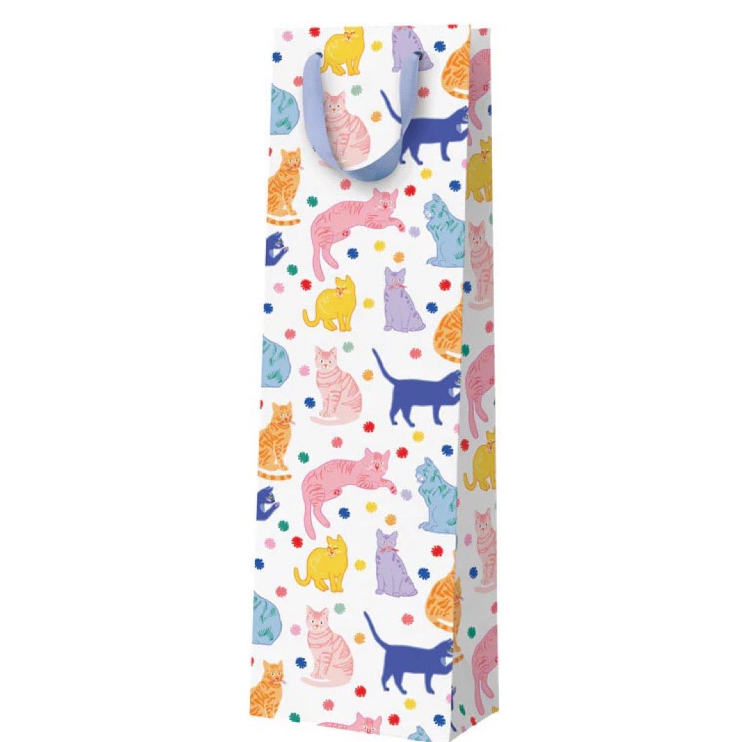 A white bottle bag with multicoloured cats and a lilac ribbon handle.