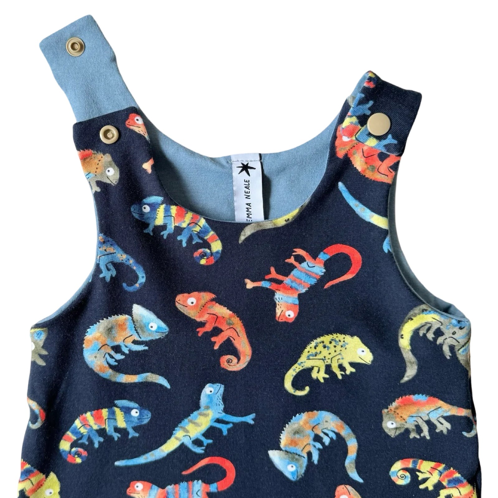 An oversized baby romper with colorful chameleon patterns.