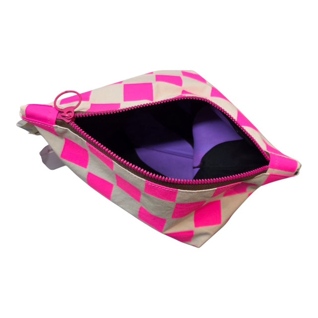The top screen-printed checked cosmetic bag in pink and white with a pink zip and purple lining.