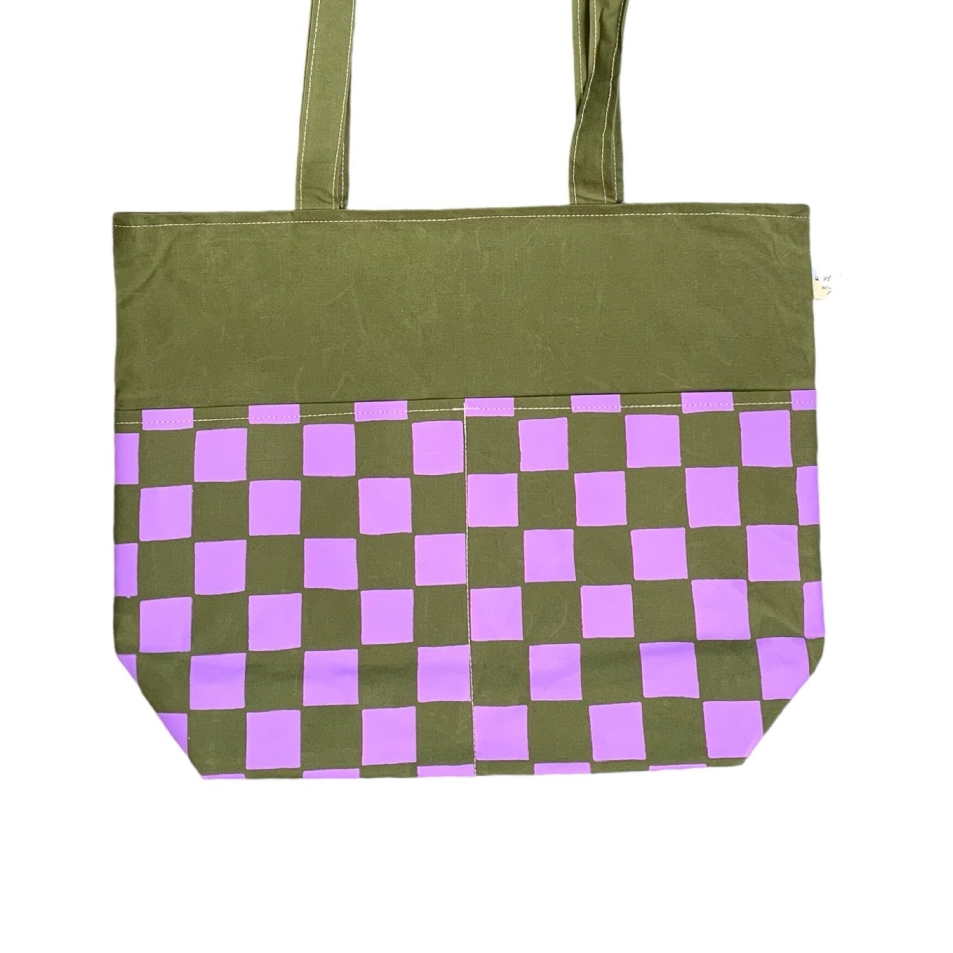 green and purple checked reversible tote bag.