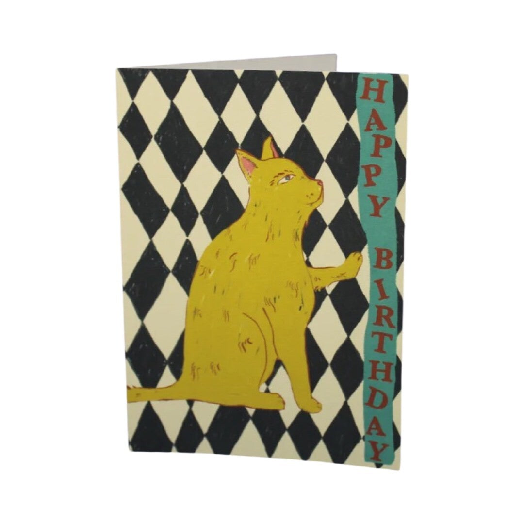 Birthday card featuring a tabby cat against a black and white checked background with the text ' Happy Birthday' written down the side of the card in red lettering on a  green banner.