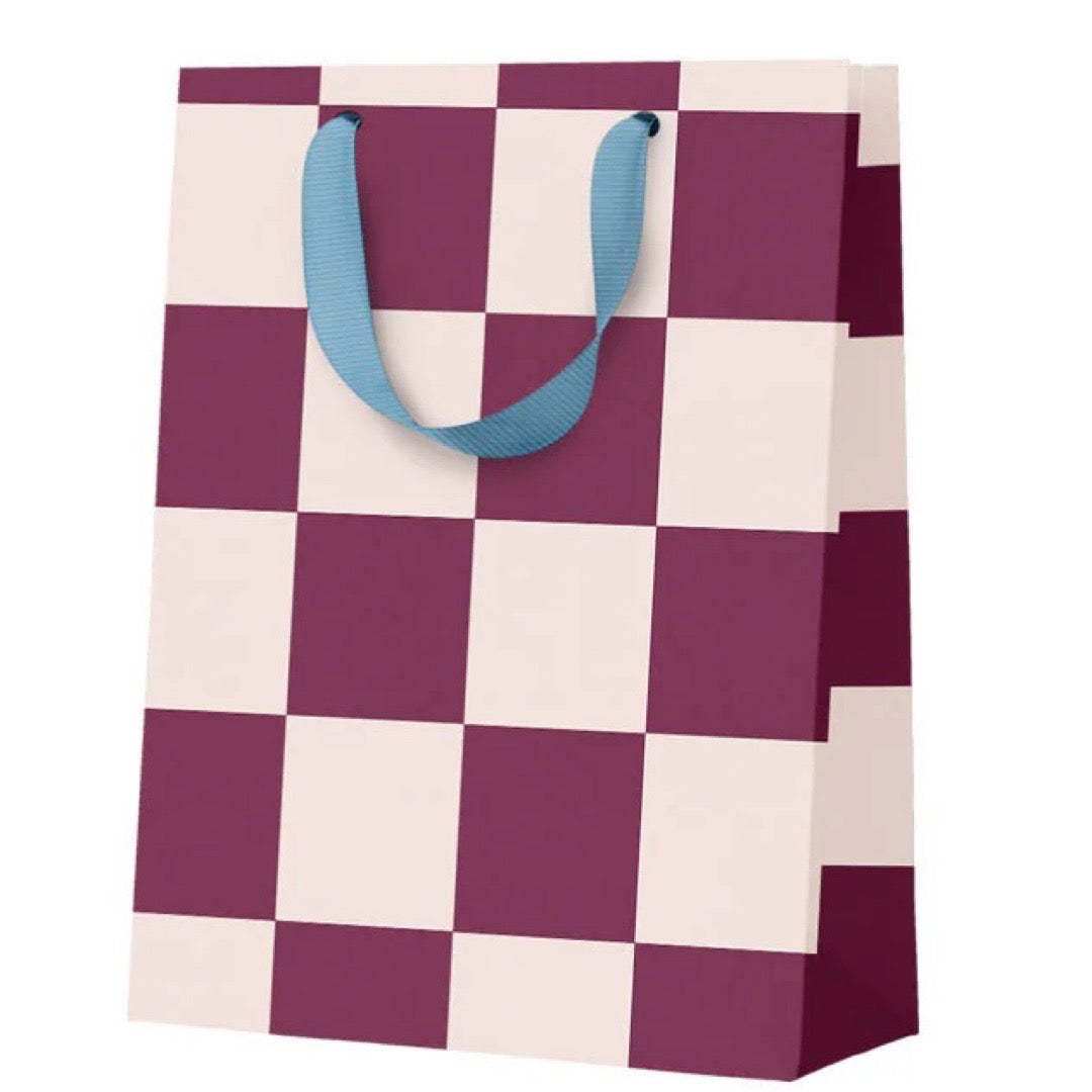 Checkered bag with purple and white squares and blue handles on a white background.
