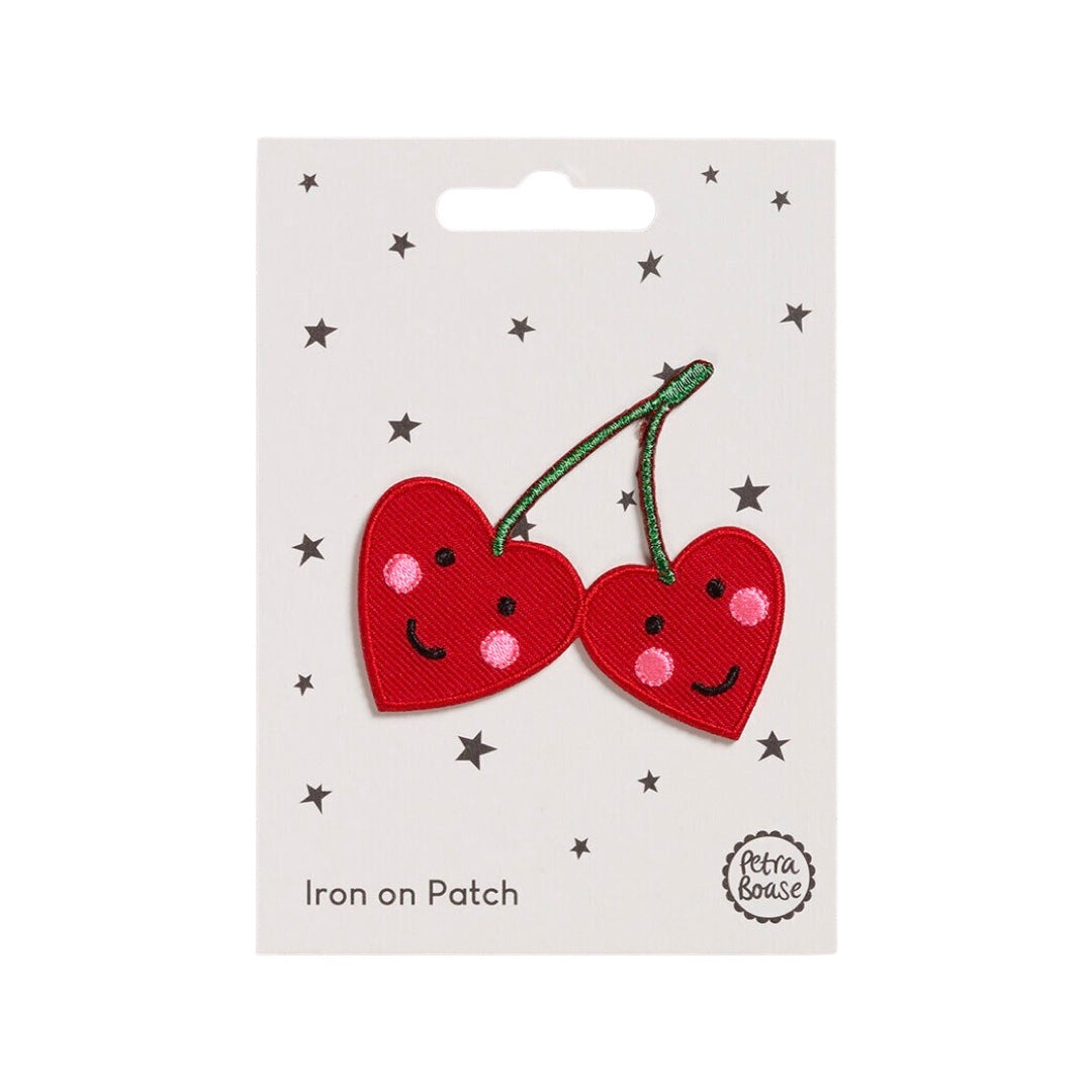 An embroidered cherries fabric patch featuring two love heart-shaped cherries with happy faces.