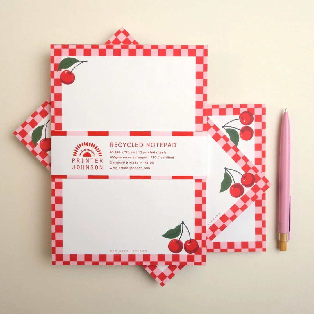 Recycled notepad with red checkered border and cherry design, featuring Printer Johnson branding.