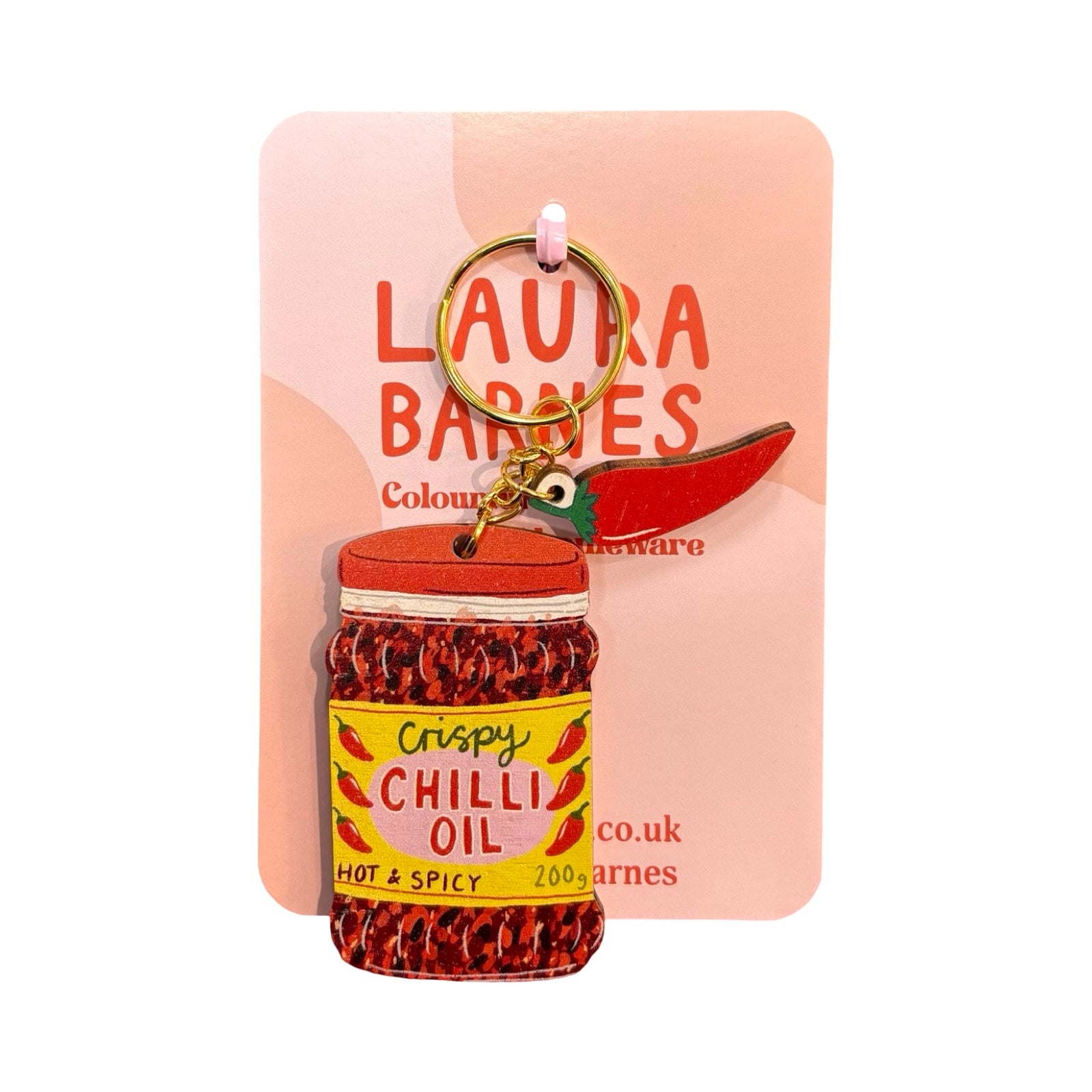 Chilli oil bottle keychain on a pink card with 'Laura Barnes' branding.
