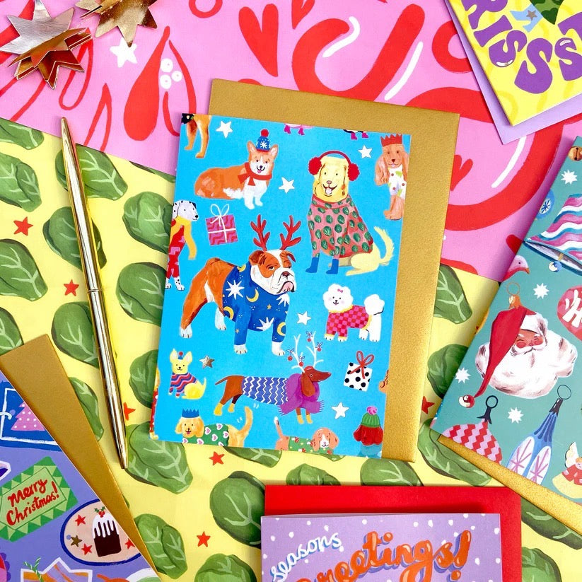 Collection of colourful greeting cards with various designs on a patterned background.