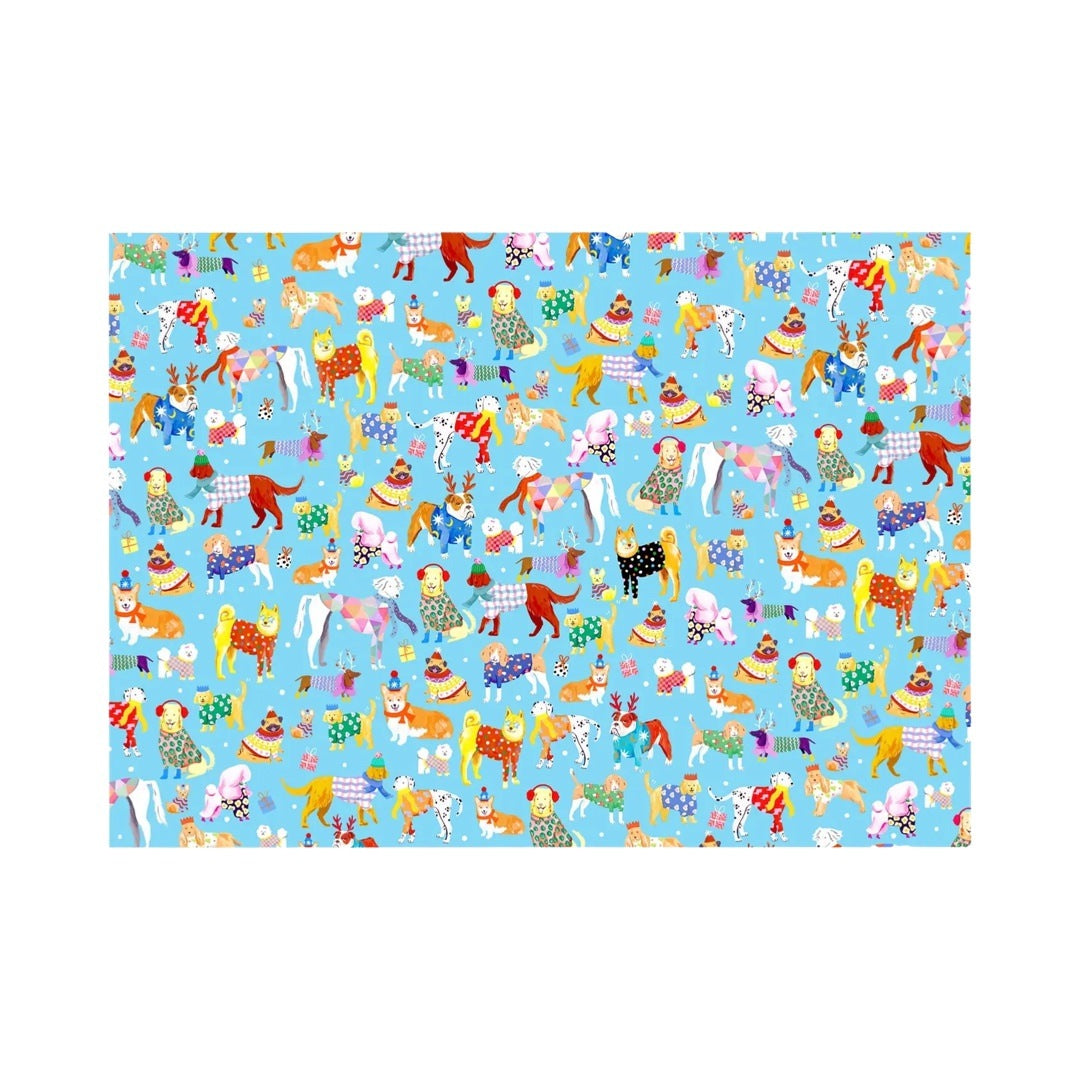 Dogalicious Christmas wrapping paper featuring a selection of festive dogs dressed in woolly jumpers, scarves and ear warmers, all on a blue background with presents and stars.