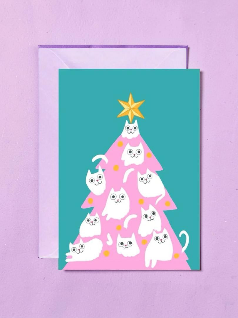Greeting card with a Christmas tree design featuring white cats on a pink background, with a purple border.