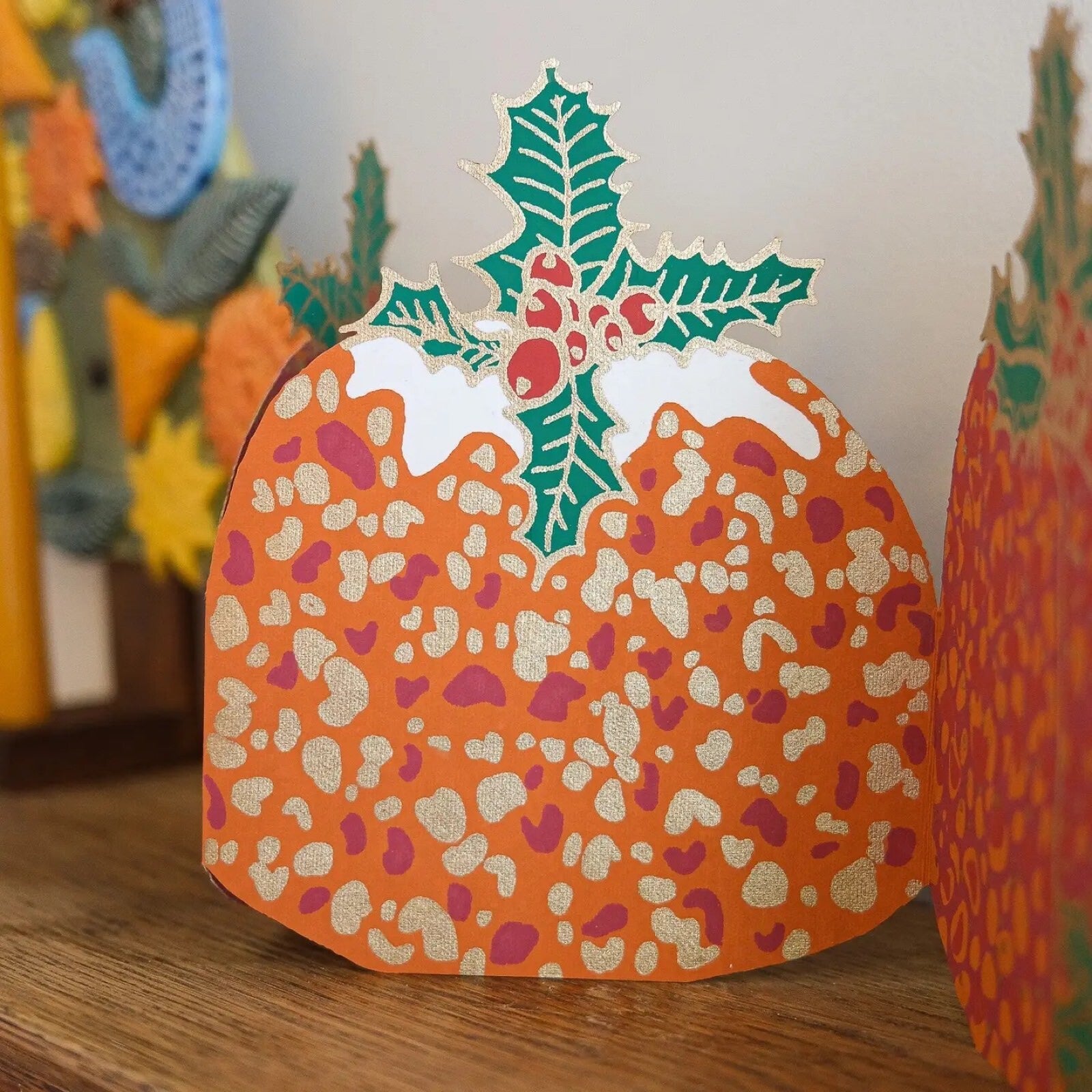 Christmas pudding paper concertina garland close up.