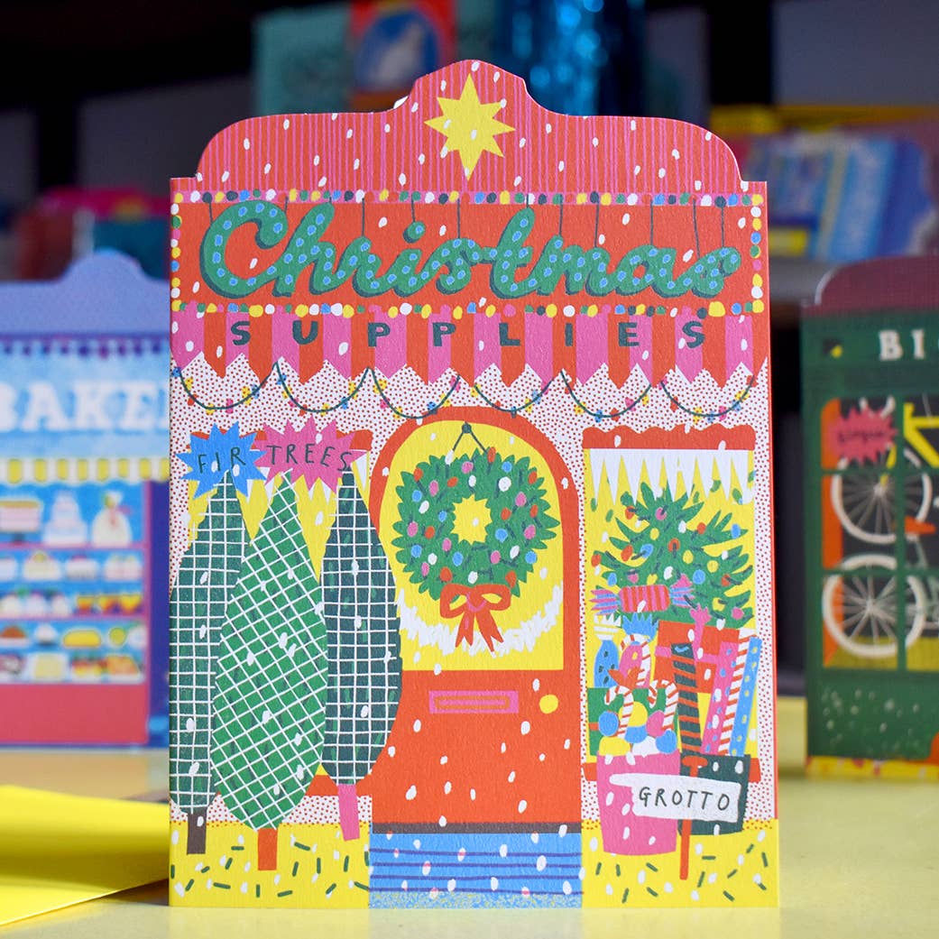 Colourful Christmas-themed card in front of other cards.