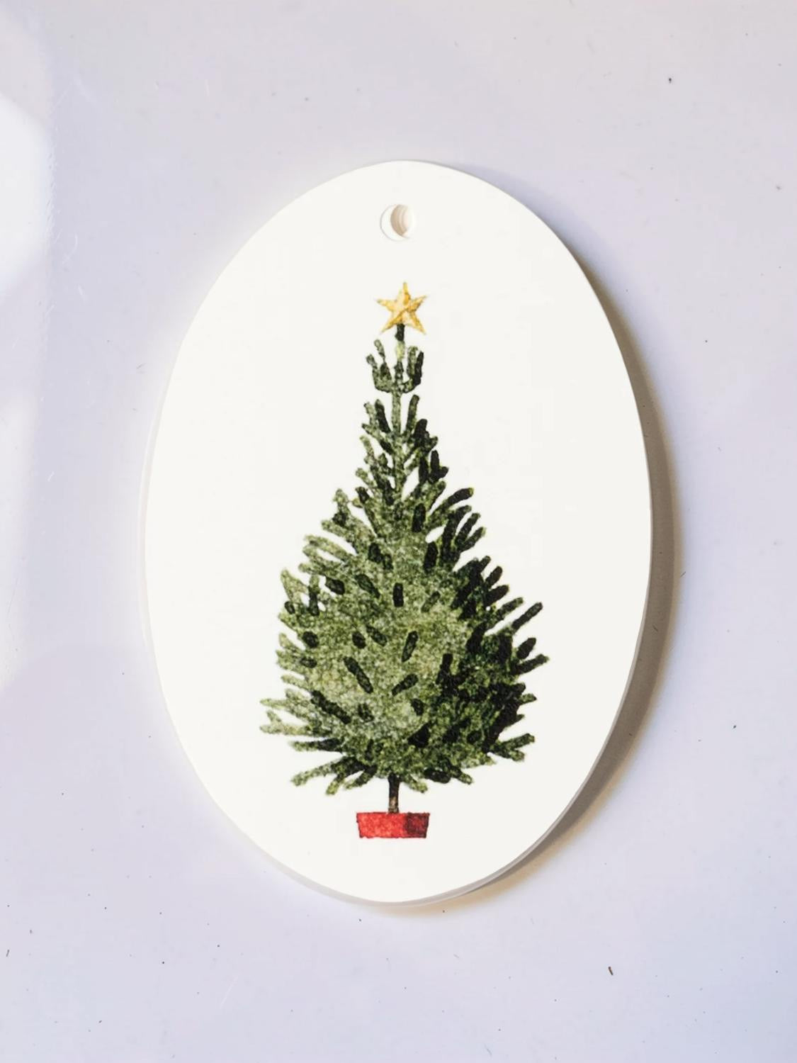 Christmas tree gift tag on a table.