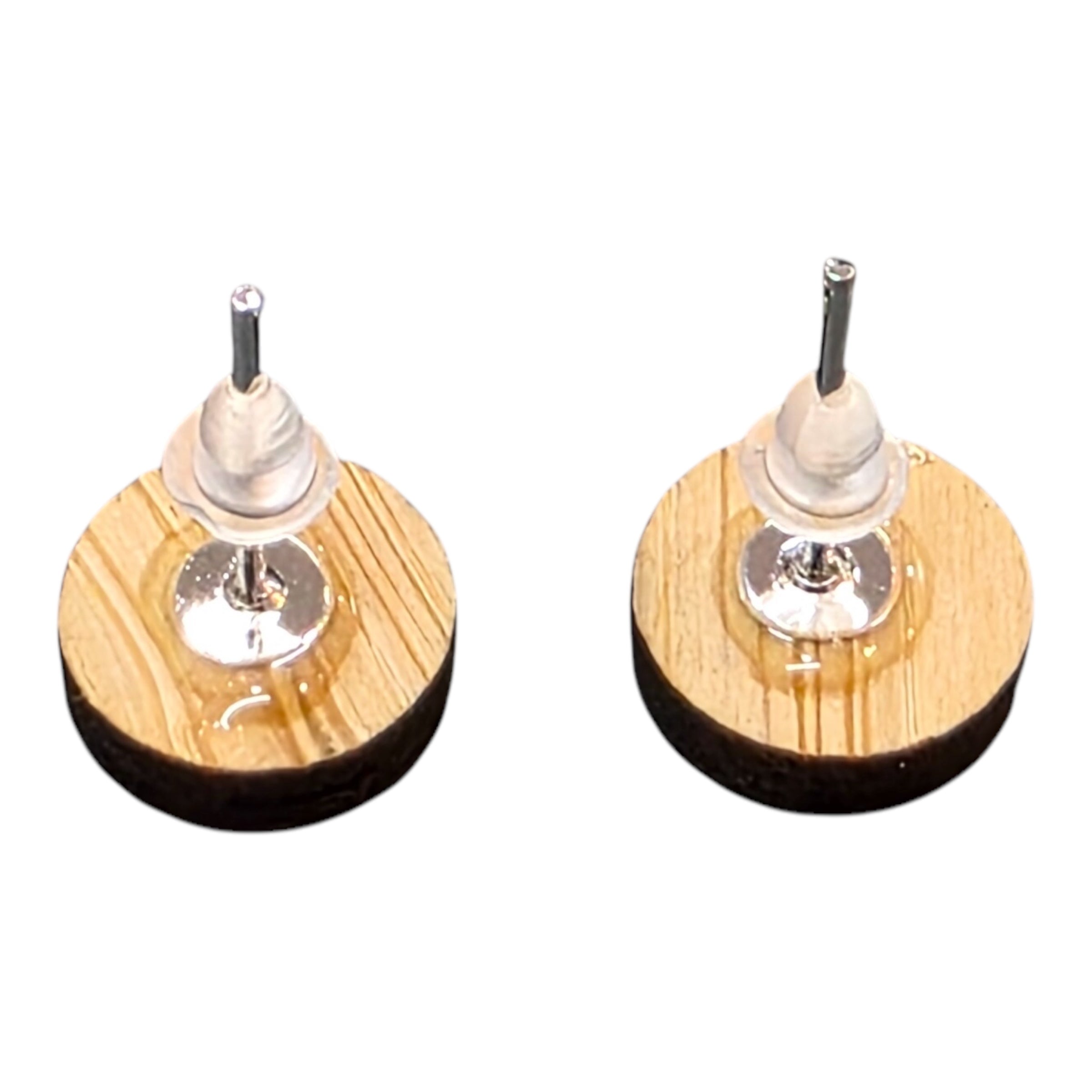 The back of a pair of wooden circular stud earrings with silver coloured posts and rubber backs.