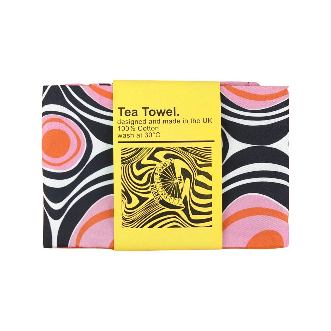 Circles Retro Tea Towel in pink and black folded with belly band.