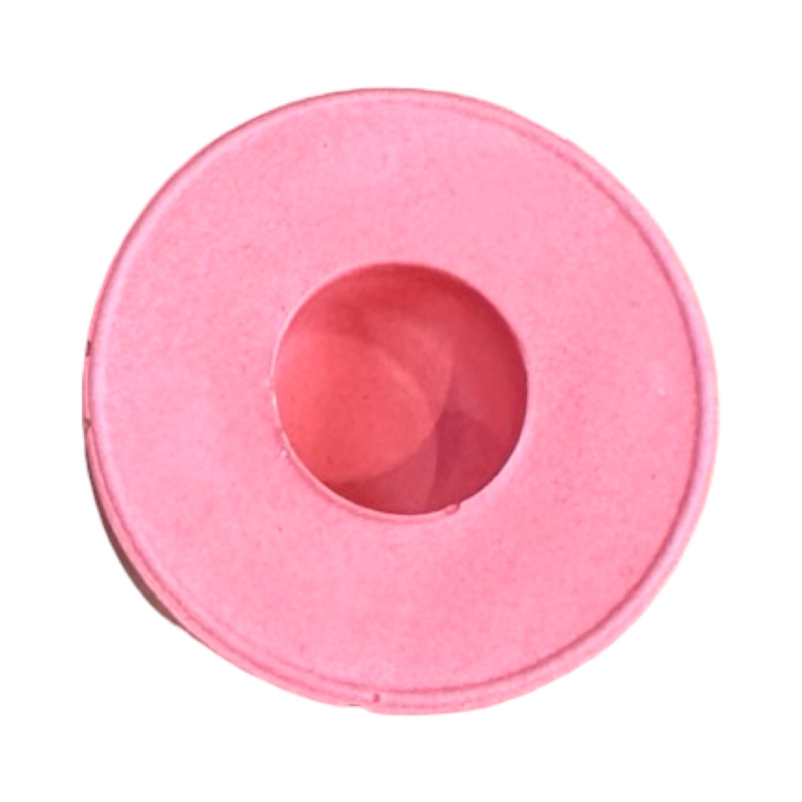 The top of a small circular dinner candle holder in pink.