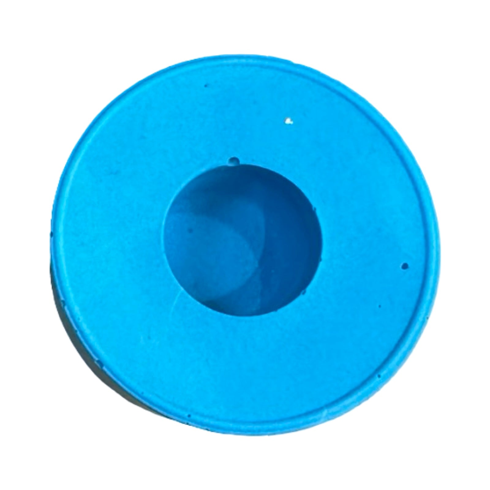The top of a small circular dinner candle holder in turquoise.