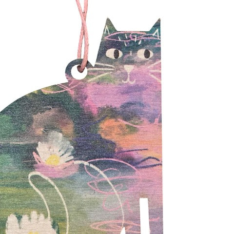 Cat-shaped wooden decoration featuring an illustration of a lily pond inspired by Claude Monet.
