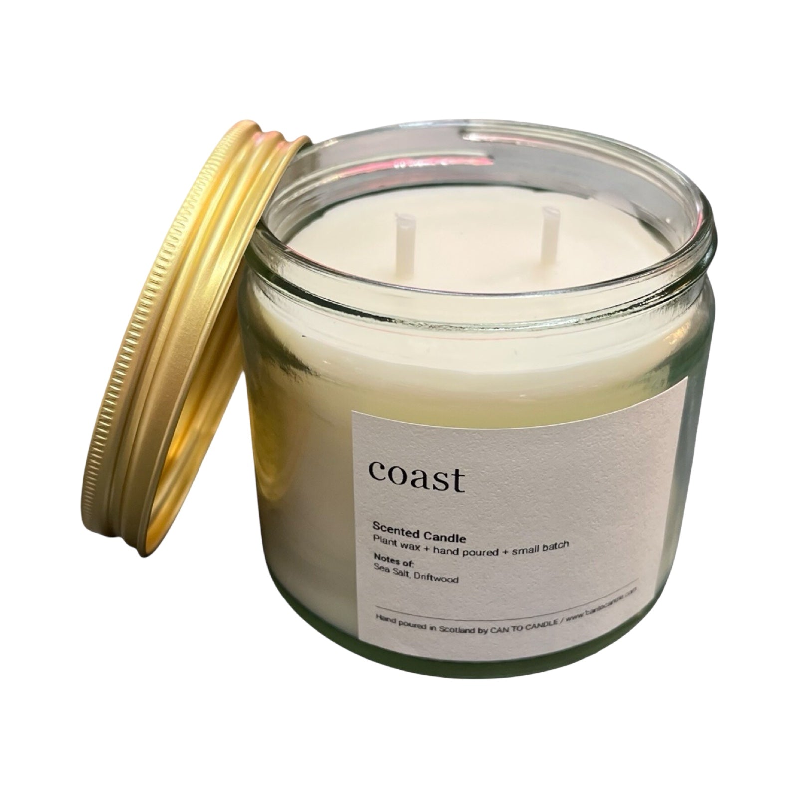Scented candle in a glass jar with a gold lid on a white background.