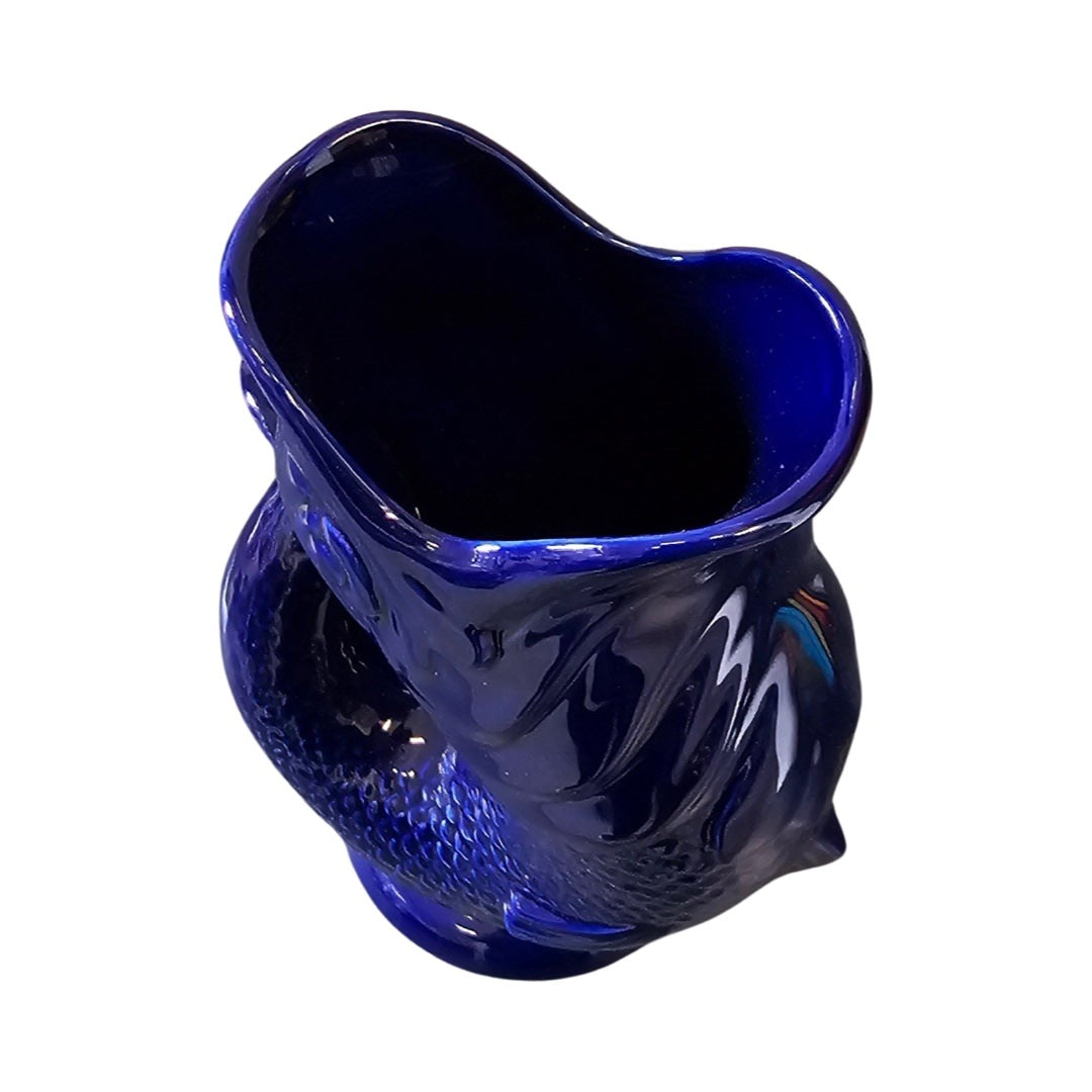 The top of a cobalt blue fish shaped gluggle jug.