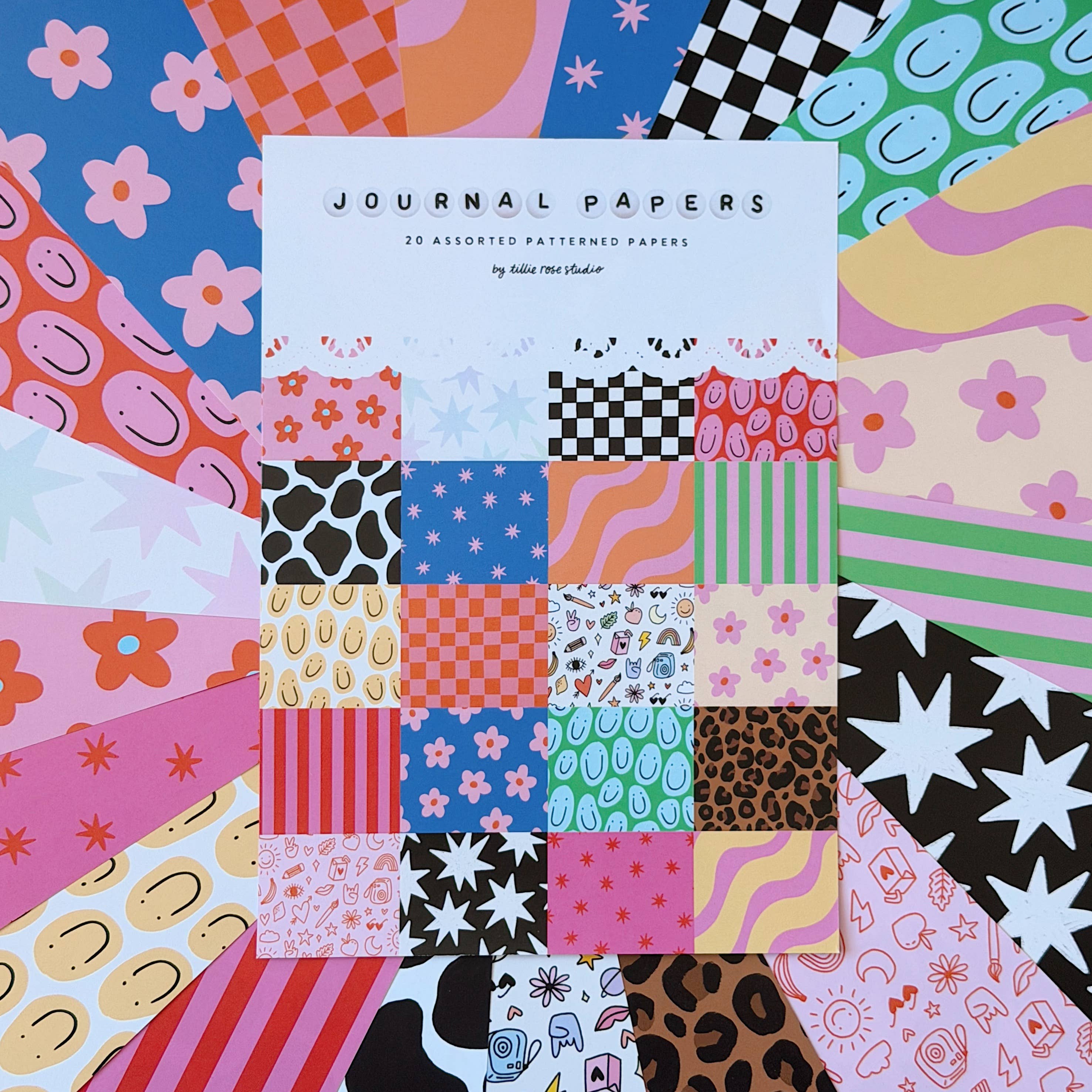 Journal Papers with assorted patterned papers on a colourful patchwork background.
