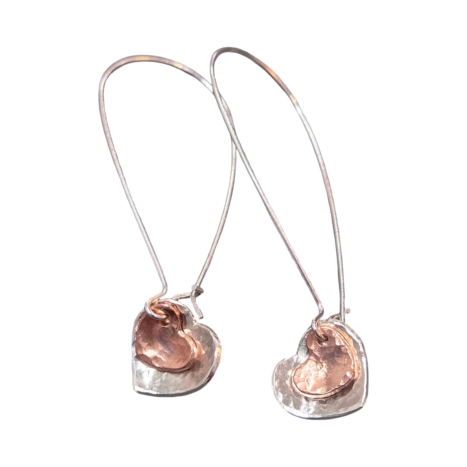 Pair of silver heart earrings with copper hearts on a white background.