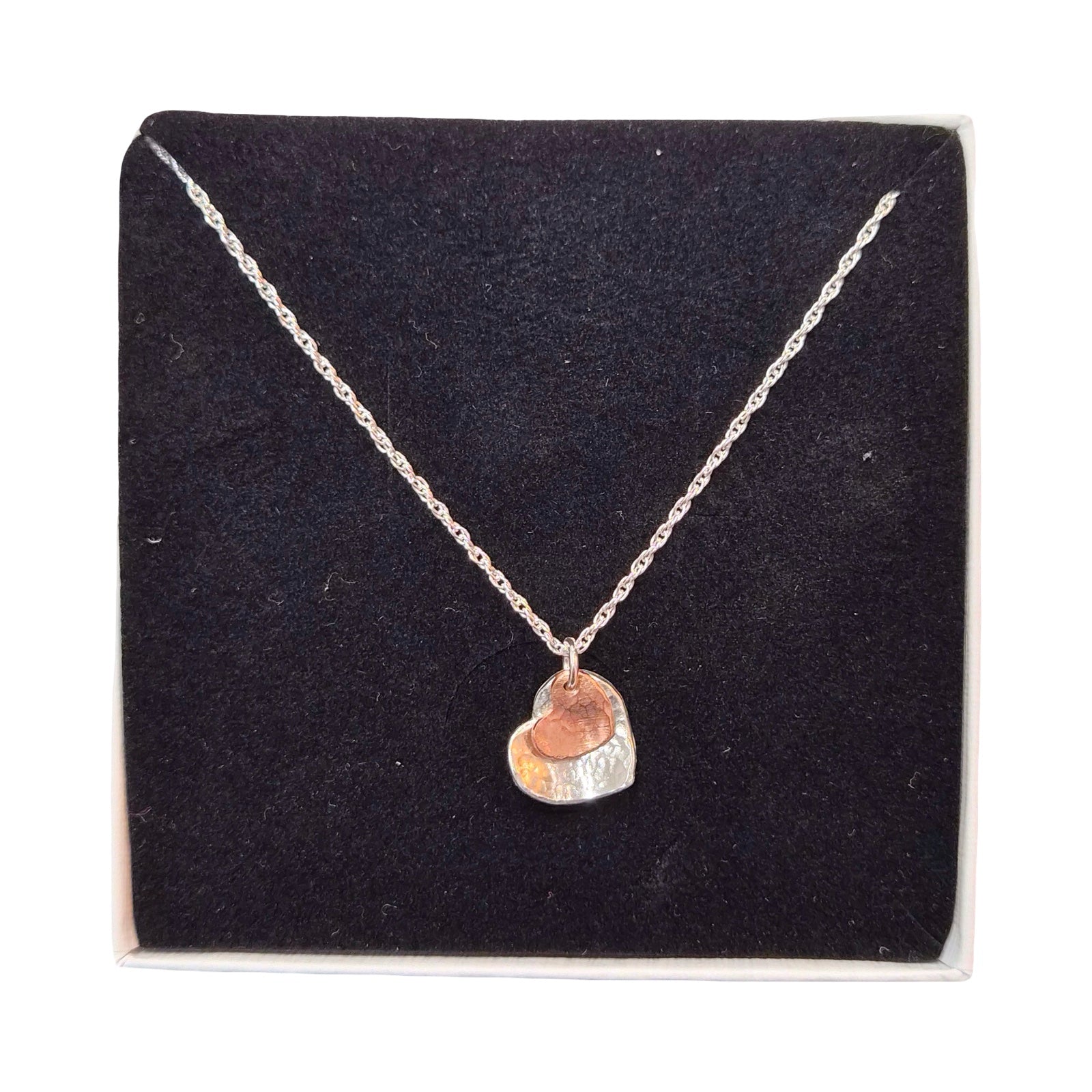 Necklace with a heart-shaped pendant on a black display card.