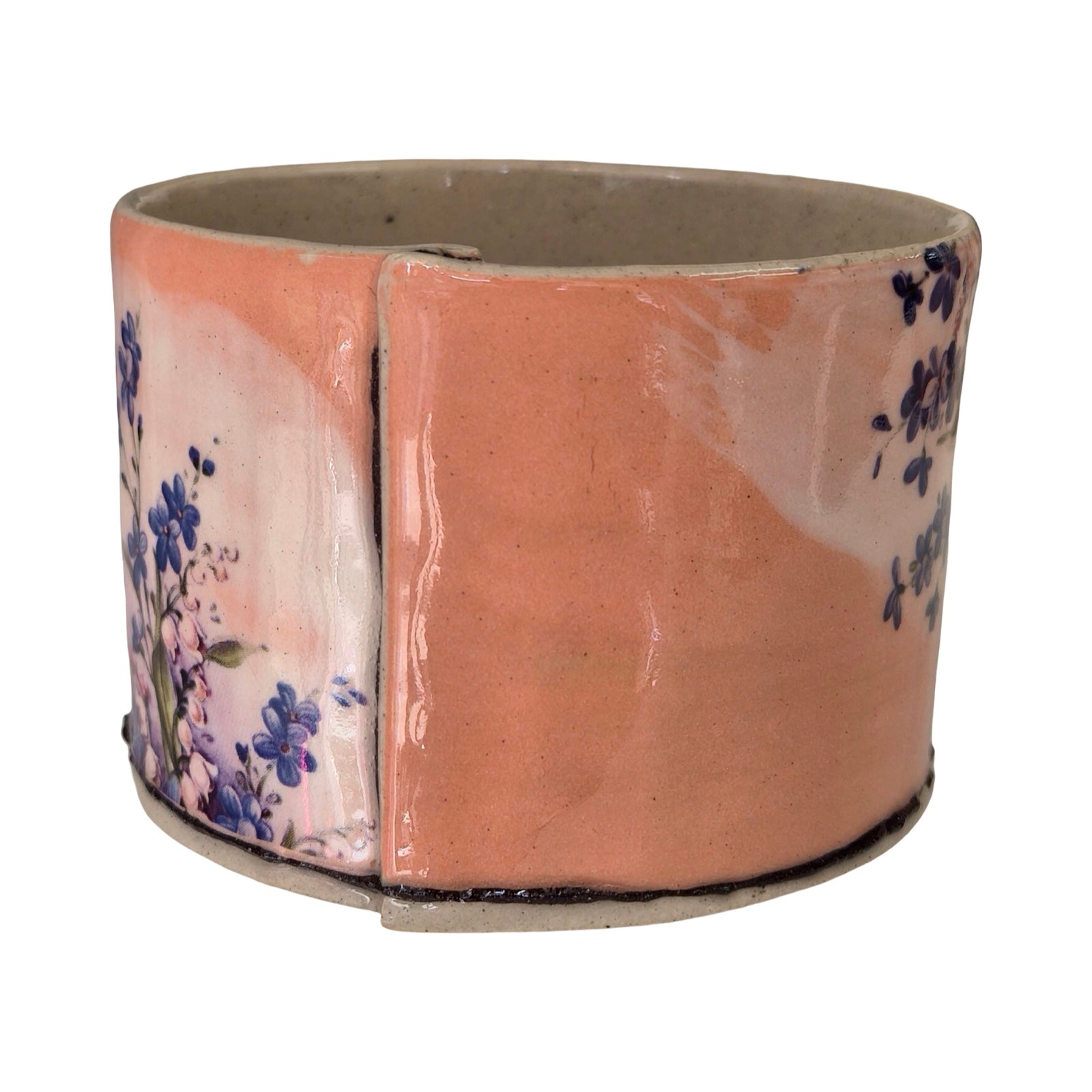 Ceramic planter with floral design on a white background.