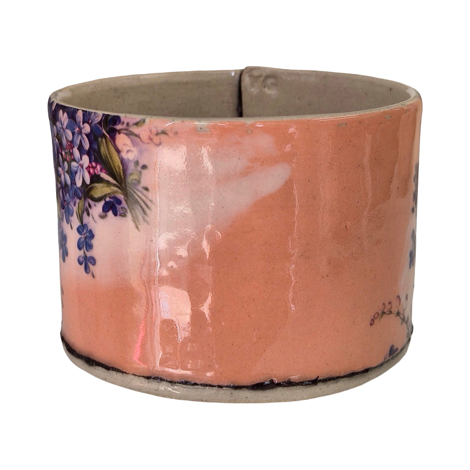 Ceramic planter with floral design on a white background.