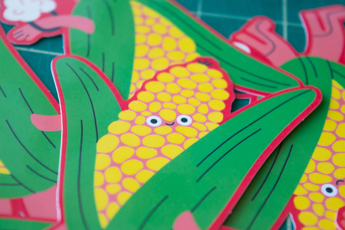 Close up of corn sticker in a pile on a green mat.