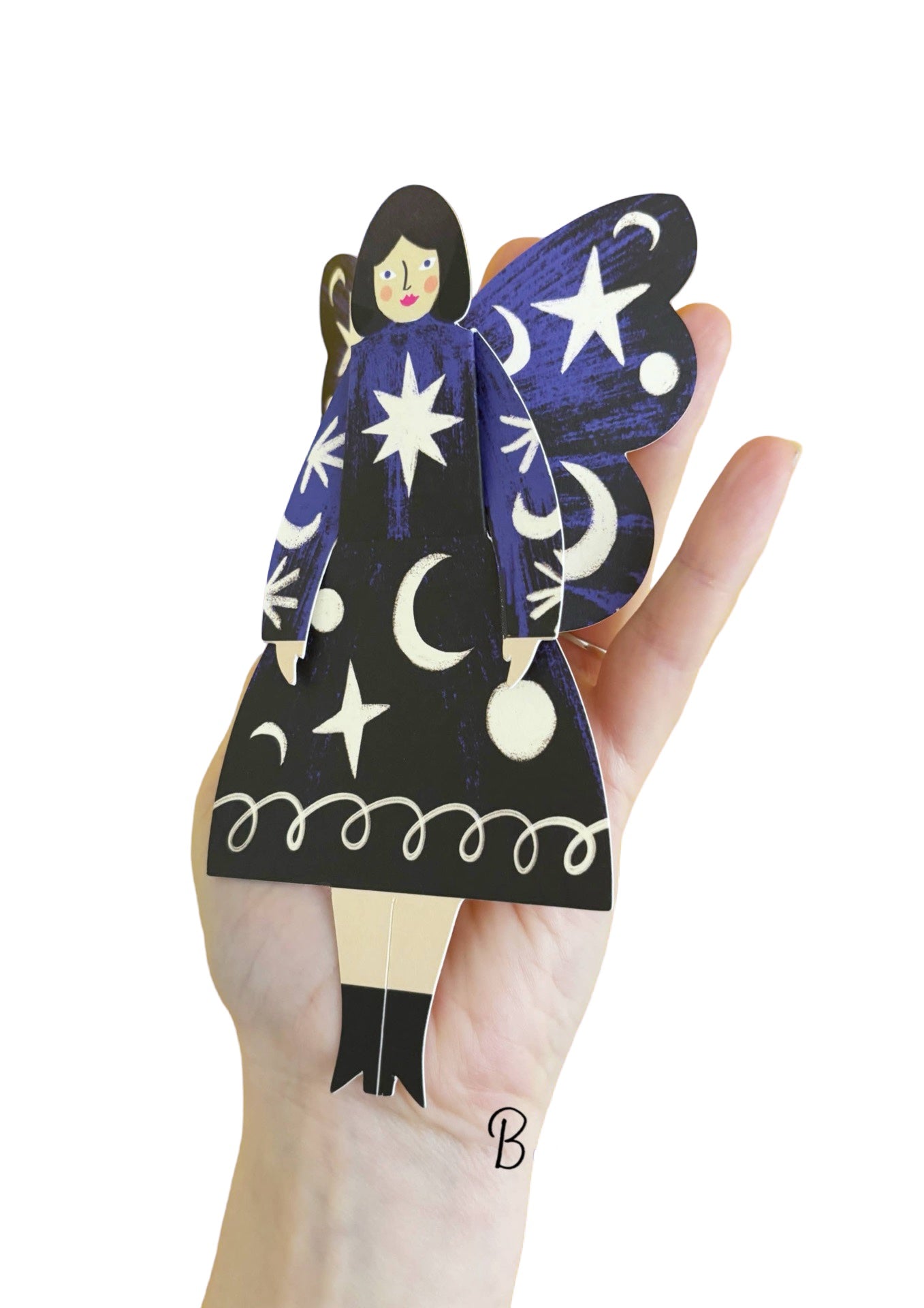 A cosmic butterfly woman card featuring a lady in a black dress with blue arms covered in stars and moons in the palm of a lady's hand.