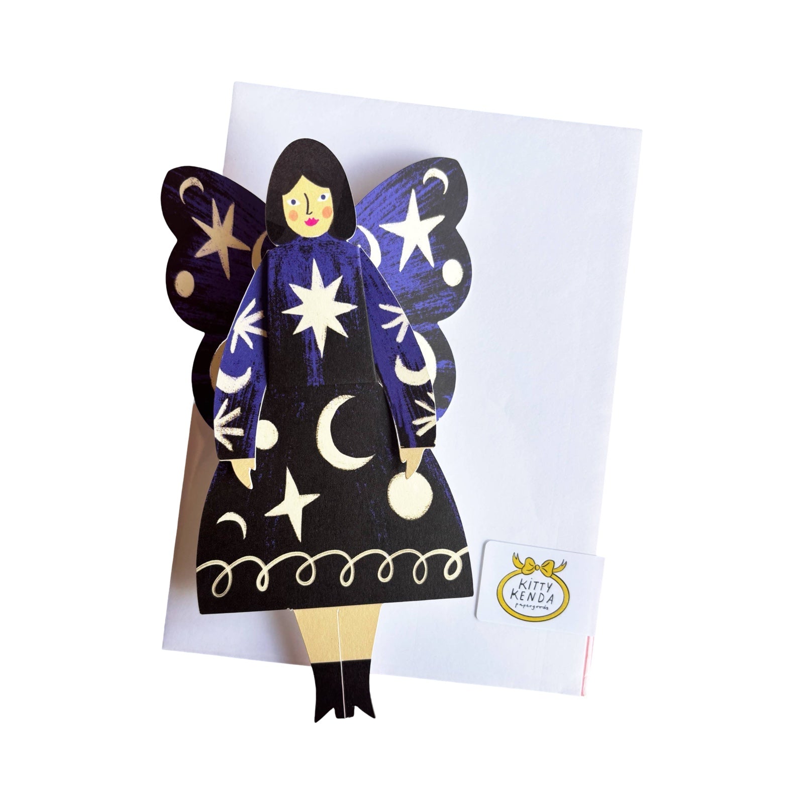 A cosmic butterfly woman card featuring a lady in a black dress with blue arms covered in stars and moons with a white envelope.