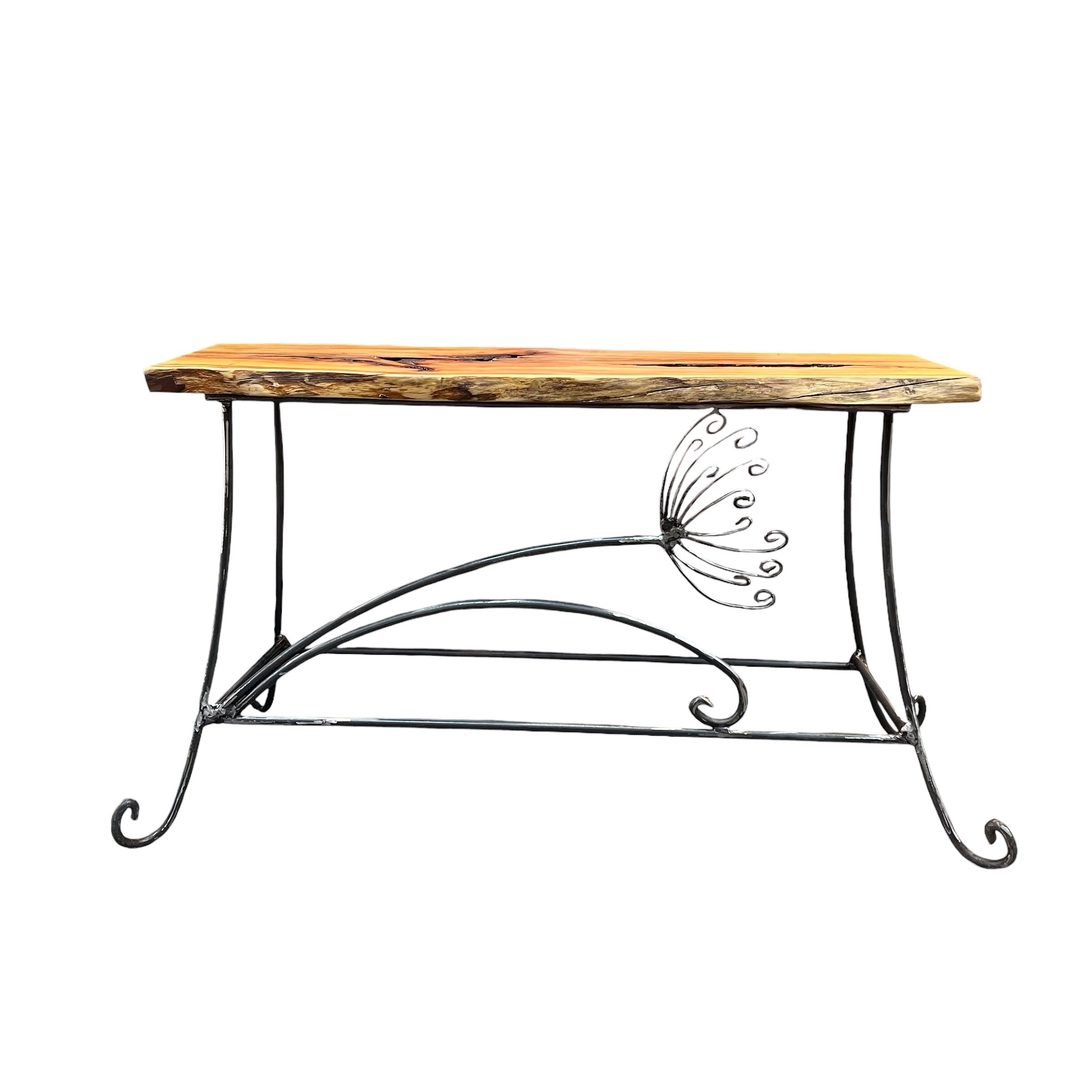 A handmade table/bench with an yew wooden top and a galvanised steel frame with a cow parsley design. Suitable for indoor or outdoor use. (Galvanised steel will dull as it weathers, but it won't rust).