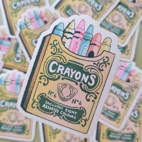 Sticker featuring a retro box of colourful crayons.