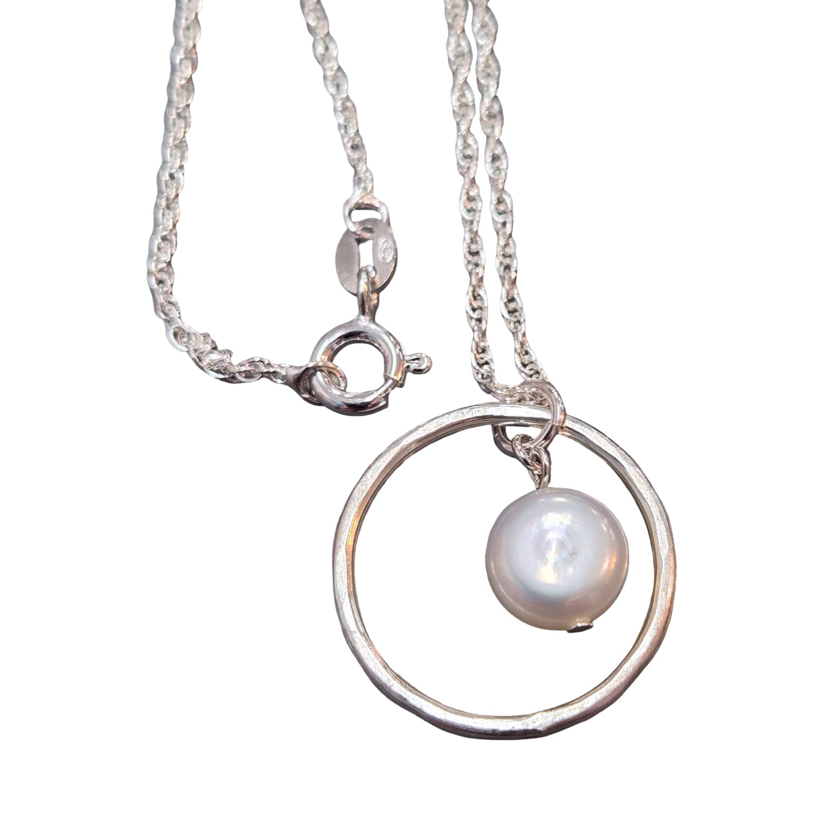 Silver necklace with a circular pendant and pearl on a white background.